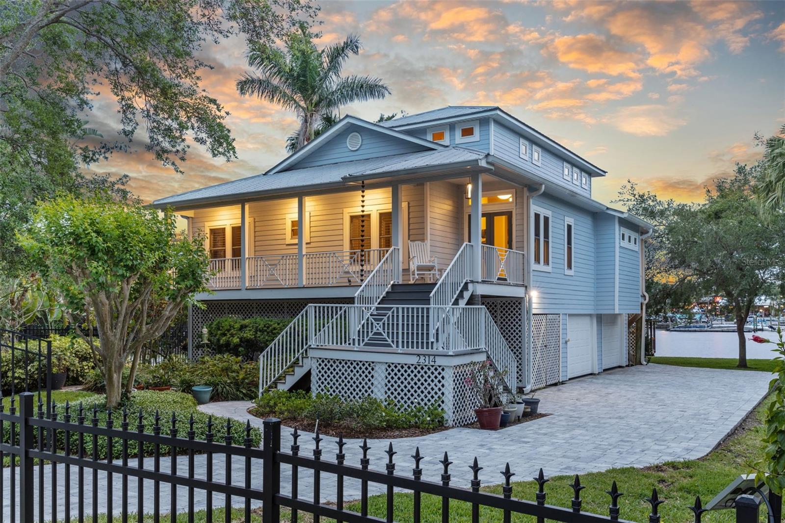 Tucked away in the highly sought-after Ridgewood Park neighborhood of Tampa Heights, this meticulously maintained Key West-style home offers rare waterfront living just minutes from the heart of downtown Tampa. With timeless charm, thoughtful upgrades, and unparalleled views, making it a true gem in The Heights.
From your private dock—complete with a covered seating area—you’ll enjoy breathtaking views of the Hillsborough River and the downtown Tampa skyline. Located directly across from the iconic Rick’s on the River and less than a mile from Armature Works, this location offers the ultimate blend of serenity and city access. Prefer to travel by water? It’s an even quicker boat ride.
The home itself is designed for comfort and functionality. The second floor is a full private master suite featuring a spacious bedroom, a large walk-in closet, and a luxurious spa like bathroom. Downstairs, the main floor includes two guest rooms (one currently used as an office), a second full bathroom, a dedicated laundry room, pantry, and an open-concept living and dining area that flows seamlessly onto a spacious back porch—an ideal extension of your living space.
Additional features include: 2-car garage with multiple storage areas, meticulously landscaped grounds and fresh (2023) pavers throughout, 75 feet of new seawall, Trex composite decking on the dock as well as from and back porch for durability, solar-powered security gate (new mechanism 2024), metal roof with all new rivets (2019), brand new hot water heater (2025), new HVAC system (2024), gorgeous new engineered wood floors upstairs (2024), stunning views, solid craftsmanship, and updates that enhance both style and longevity, this home is a rare opportunity to own a piece of authentic waterfront living in one of Tampa’s most vibrant neighborhoods. There is no history of water intrusion into the living area of the home. There is an assumable flood insurance policy as well.