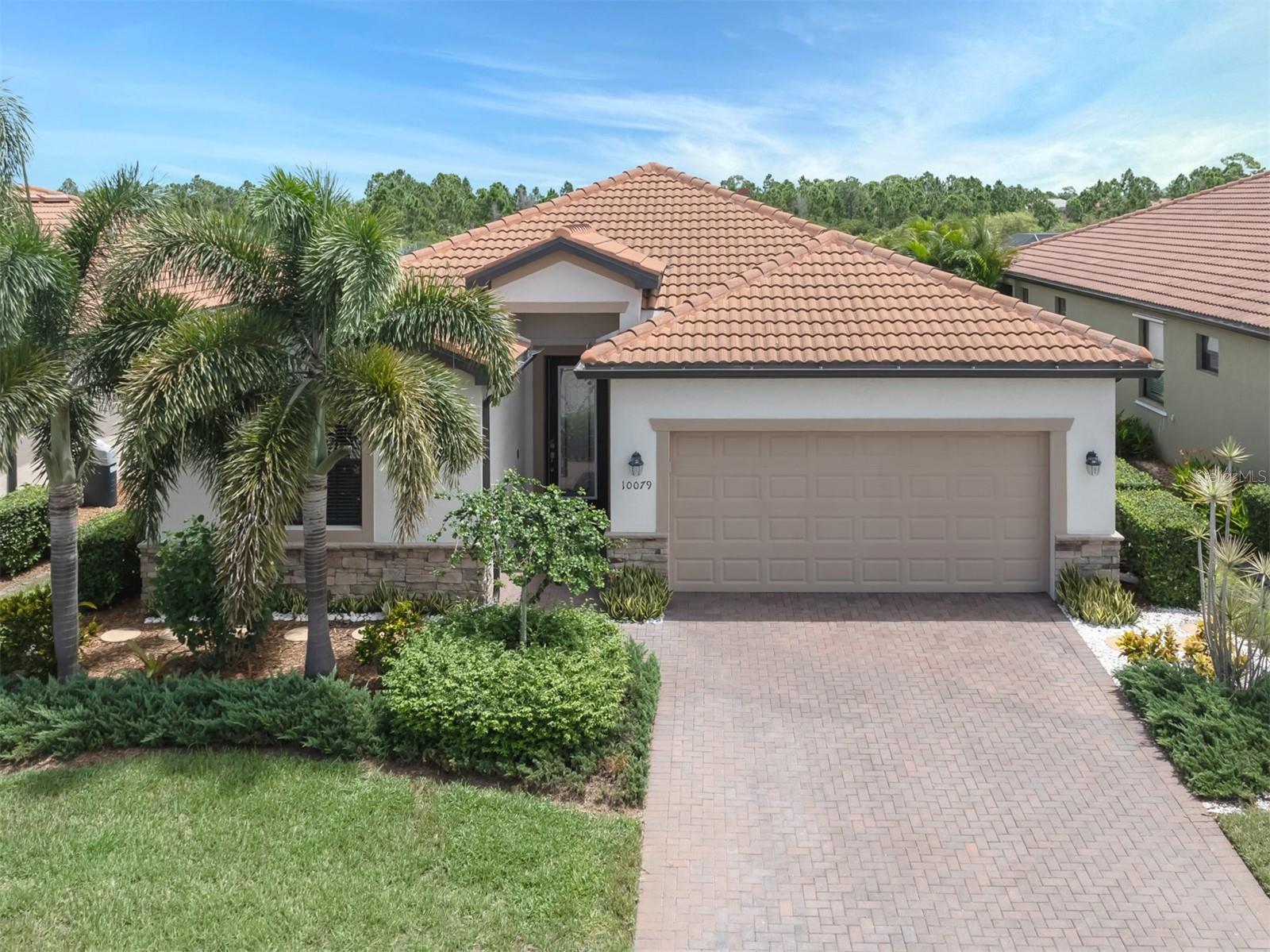 Priced to sell! This meticulously maintained 2,032 square foot home offers lots of privacy with a beautiful PRESERVE VIEW and LOTS of privacy shows like a model! This award-winning TREVI model boasts 3 bedrooms, 3 baths, DEN, a two-car garage, great room, tile throughout the main living area, FULL HURRICANE PROTECTION, whole-house water softener and more. From the moment you walk through the front door you are welcomed by an open and airy floor plan that seamlessly integrates the great room, dining room and kitchen areas. The great room is spacious and inviting, ideal for relaxing with family and entertaining guests. Large windows allow natural light to flood the space, creating a bright and cheerful ambiance throughout the home. The open kitchen is a chef's delight, featuring top-of-the-line appliances, granite countertops, solid wood cabinetry, breakfast bar and closet pantry. Whether you're preparing a casual meal or hosting a dinner party, this kitchen provides everything you need with style and functionality. The primary suite is a sanctuary, offering a peaceful retreat with a generous layout, dual walk-in closets and a luxurious en-suite bath complete with modern fixtures, a soaking tub, separate shower and private water closet. The second bedroom includes a private en-suite and the two additional bedrooms are near the third full bath providing comfort and privacy for family members and guests. The beautifully landscaped backyard is a private oasis, complete with hot tub and covered patio area, and includes whole house water softener. The lot can easily accommodate a custom pool. Live every day like you are on vacation in this resort-style community. This community boasts a 30,000 square foot clubhouse with resort-style pool, outdoor tiki, a coffee room, Palm Club restaurant, 7,000 square foot fitness center, fitness classes, day spa, card room, bocce ball, pickleball, tennis, dog park, playground and event lawn. Sarasota National has also been certified by the International Audubon Society. Near the new Atlanta Braves spring training ballpark, newly built downtown Wellen Park, pristine beaches, newly built Costco, shopping, dining, medical facilities, U.S. 41 and Interstate 75.
