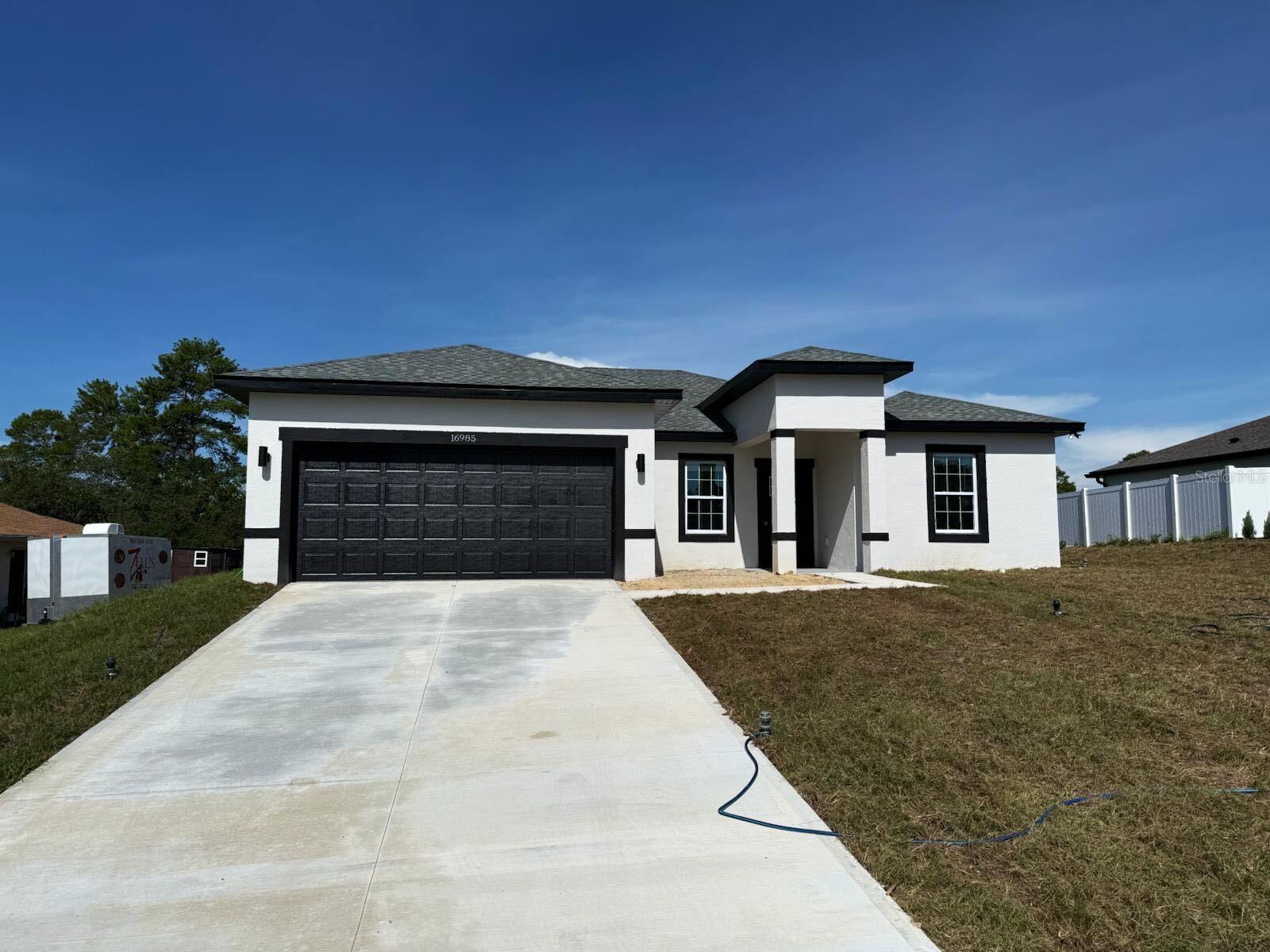 Under Construction. This beautifully designed Arpoador model features 4 spacious bedrooms, 3 full bathrooms, and 1,891 sq ft of heated living space, with a total construction area of 2,333 sq ft. The home is finished with SLEEK Dark FIXTURES AND ACCENTS, giving it a clean, modern aesthetic throughout.
The open-concept kitchen is a showstopper with a WATERFALL QUARTZ ISLAND with a striking dark slatted wood accent and comes fully equipped with stainless steel appliances—refrigerator, range, microwave, dishwasher, and disposal.
The luxurious owner’s suite offers a STANDALONE TUB, glass-enclosed SHOWER DOOR, and dual vanities. Additional highlights include a SMART KEY entry system, double car garage, covered entry, and a 2-10 HOME WARRANTY for added peace of mind.
Receive up to $1,000 in lender credits toward appraisal and credit report when financing through On Target Mortgage, our preferred lender.
Don’t miss this opportunity—schedule your private showing today!