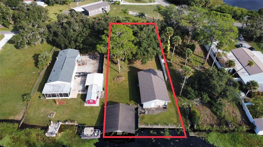 Fall in love with this peaceful canal-front property, featuring a 1,196 sq. ft. cinder block garage with a newer roof (2022) and blueprints to complete your dream home or weekend retreat. Enjoy your private dock with boat lift, septic tank, and Mullet Lake Water Association drinking water.Escape to the quiet charm of Geneva and make this beautiful waterfront spot your own!Cider Block structure built in 1968 ALL MEASUREMENTS ARE APPROXIMATE! BLUEPRINTS, SURVEY, AND BUILDER INFORMATION ARE AVAILABLE!