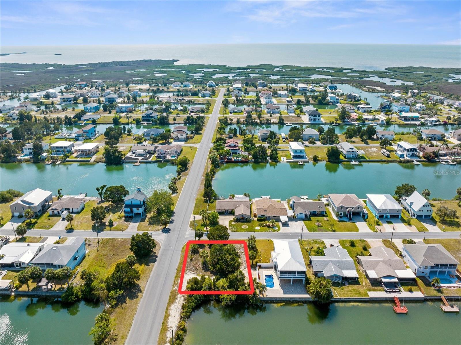 This exceptional corner lot offers 79 feet of waterfront on a wide saltwater canal with direct Gulf access via the community boat lift. Located in a quiet, coastal neighborhood with no HOA, it’s the perfect spot to design and build your custom dream home. Zoned R1C and ready for a single-family residence, with public utilities available.
Don’t wait—bring your vision to life and enjoy the best of Florida’s coastal lifestyle: boating, fishing, sunsets, and relaxed waterfront living all from your backyard.