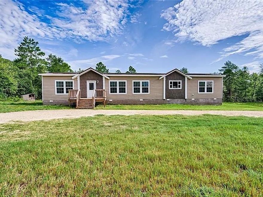 Spacious 4-bedroom, 2-bath home situated on 1.25 acres, offering the perfect blend of privacy and functionality. The property features a well- designed floor plan beginning with a generous size kitchen which provides ample cabinet and counter space and opens to the main living and family room characterized with wood beams and an accent wall making it perfect for everyday living and entertaining. The primary suite includes a private bath with a soak tub surrounded by stone accents a separate shower and walk in closets while three additional bedrooms offer flexibility for family, office or hobby use. The laundry room is equally spacious with its own island, sink, refrigerator and a significant amount of counterspace. Economically you can benefit from a metal roof with solar panels that will significantly lower your utility bills. Enjoy outdoor living with plenty of room for recreation, gardening or future improvements while still being a short commute to Gainesville's shopping, restaurants and major medical facilities.