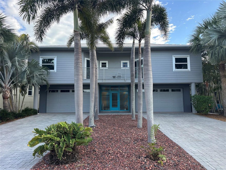 Steps away from the white sand Gulf beaches in the heart of prestigious Belleair Beach community. This modern coastal elevated home blends architectural sophistication with European elegance spanning 3,450 total square feet. Step through to a designer open floor plan flowing seamlessly for impressive entertaining and effortless living. Spacious light-filled living areas feature floor to ceiling impact rated sliding glass doors and windows, warm exotic hardwood flooring, and a modern electric fireplace for relaxed ambiance. The bespoke kitchen features high quality solid maple interior cabinetry with Italian high gloss finish, reflecting Murano glass backsplash, premium Jenn-Air and Bosch stainless steel appliances, and shimmering Blue Pearl granite countertops. Additional features include an efficient walk-in pantry incorporating additional cabinetry and counter space. The spacious south-facing balcony serves as a private elevated outdoor oasis perfect for peaceful morning coffee and al fresco dining. The primary bedroom provides a private retreat with an exquisite ensuite double sink vanity, walk-in shower, Whirlpool massaging tub, and walk-in closet. Additional bedrooms are equally well-appointed sharing a double vanity Jack and Jill bath with a tub/shower combo and access to a shaded north-facing balcony. An open-concept third floor loft can serve as a flexible space, yoga studio, recreation area, or private home office. The downstairs features durable porcelain tile flooring, newly installed white high gloss cabinetry, quartz countertops, and a versatile separate entry studio space all connecting to a lush tropical garden. The expansive covered patio features an outdoor kitchen, convenient outdoor shower, low maintenance composite decking centered around a serene outdoor fountain, perfect for relaxing after a day at the beach or hosting guests. Immerse yourself in the Belleair Beach lifestyle with resident-only beach parking, three private beach entrances, and a community center offering tennis/pickleball, and recreation grounds, all just a short golf cart ride away. This exceptional, move-in ready contemporary custom built home is a timeless investment in luxury beachside living. Conveniently located close to upscale shopping, fine dining, and the Belleair Causeway boat ramp.