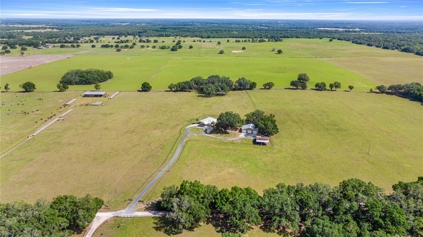 Breathtaking farm surround by absolutely stunning views! This 10 acre ranch is perfect for a cattle or horse farm. Located about 20 minutes from WEC and HITS, this gives you the feel of privacy and country living while being just minutes from everything. The 3 bedroom, 2 bath home has LVP floors throughout, hand hewn hickory base boards and Pella wood windows in the Living Room overlooking the gorgeous pool area. a BRAND NEW AC was installed in 2025 and the METAL ROOF was added 7 years ago and the GARAGE ROOF is only 2 years old. The kitchen has 2023 Dishwasher and Range and a 2025 Refrigerator that with hickory cabinets and granite counters for a beautiful, rich look. There is also a dedicated office and an oversized GATHERING AREA which is perfect for family gatherings. The pool area and lanai are truly perfect. Sit on the covered lanai and listen to the pool waterfalls while looking at the storybook views. Pool pump and filter are only 5 years old. And the jacuzzi stays with the home for those achy muscles after a day of riding and farming. The 53'x40', 3 bay garage is a CAR LOVER'S dream!! Plenty of room for farm equipment and even a car lift for the true gear heads. There is also an air conditioned office and storage area in the garage. The no climb fence and nutrient rich soil is the perfect recipe for whatever you can dream up! The 10 acre property is surrounded by an additional 53 ACRE PARCEL that can also be purchased for a total of 63 ACRES. There is a 60'x100' hay barn as on the 53 acre parcel as well. Come experience this magnificent property!!