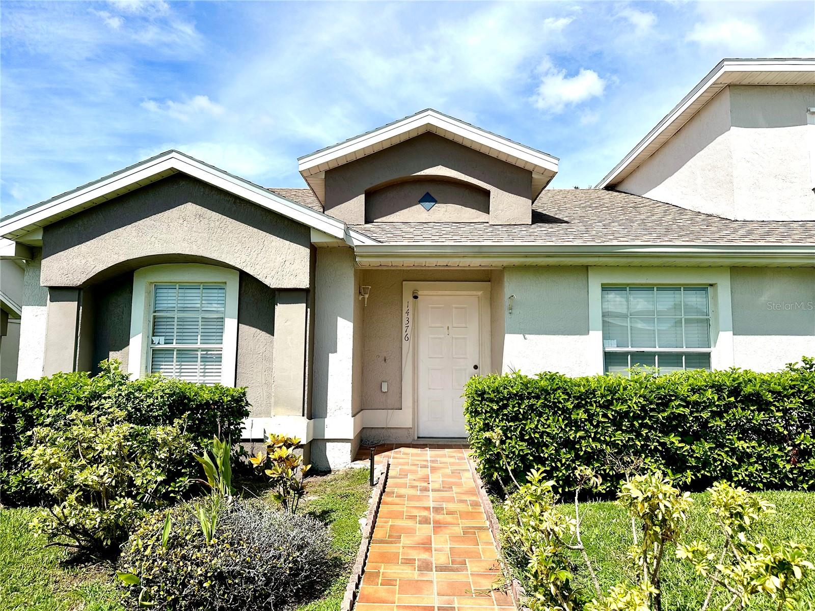 Welcome to this delightful 3-bedroom, 2-bath end-unit villa located in the peaceful Island Cove Villas of Meadow Woods. This single-story home offers an open layout with vaulted ceilings, brand-new tile floors, and a freshly painted interior that feels bright and inviting. The updated kitchen features wood cabinetry, granite countertops, stainless steel appliances, and a breakfast bar that opens to the living area. A split-bedroom plan provides privacy, with the master suite tucked at the rear overlooking the pond, complete with an en-suite bath and walk-in closet. Enjoy the Florida lifestyle with both a screened front porch and a screened lanai at the back, perfect for relaxing while taking in serene water views. The community offers a sparkling pool, well-kept landscaping, and low-maintenance living with HOA coverage for lawn care, exterior upkeep, and water. Conveniently situated near SR 417, Florida’s Turnpike, and just minutes from Orlando International Airport, Lake Nona Medical City, shopping, dining, and schools, this home combines comfort, location, and lifestyle — truly move-in ready.