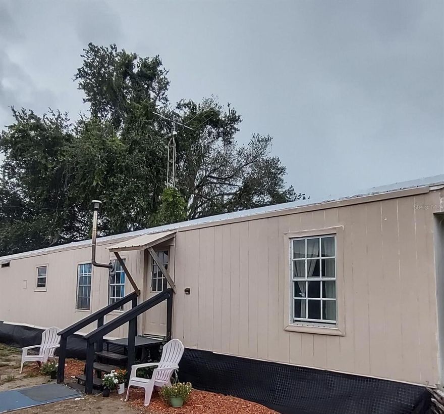Not fancy  but could be. Now a home that's just practical, flexible, and affordable offering freedom for your own way of living.  Great opportunity to live with your horses or farm animals just outside of Ocala. (Marion county allows 4 horses acre with this agricultural zoning.) Build your dream home, build your ranch or live economically in the 2/2  mobile home.currently has tenants. Please do not disturb. All working utilities - electric ,well, septic. Mobile sits on 1 acre zoned agriculture in Marion county Fl. Hugh barn shed and horse fenced. Ideal peaceful private place to start your homestead or just chill in the country atmosphere.Yet only 20 minutes to the  entertainment and shopping of The Villages or  the attractions of Ocala. Also an easy trip to the beaches or Disney and Orlando. Utilities, convenient location and sought after agricultural zoning make this an excellent property. No warrenty with buildings.
