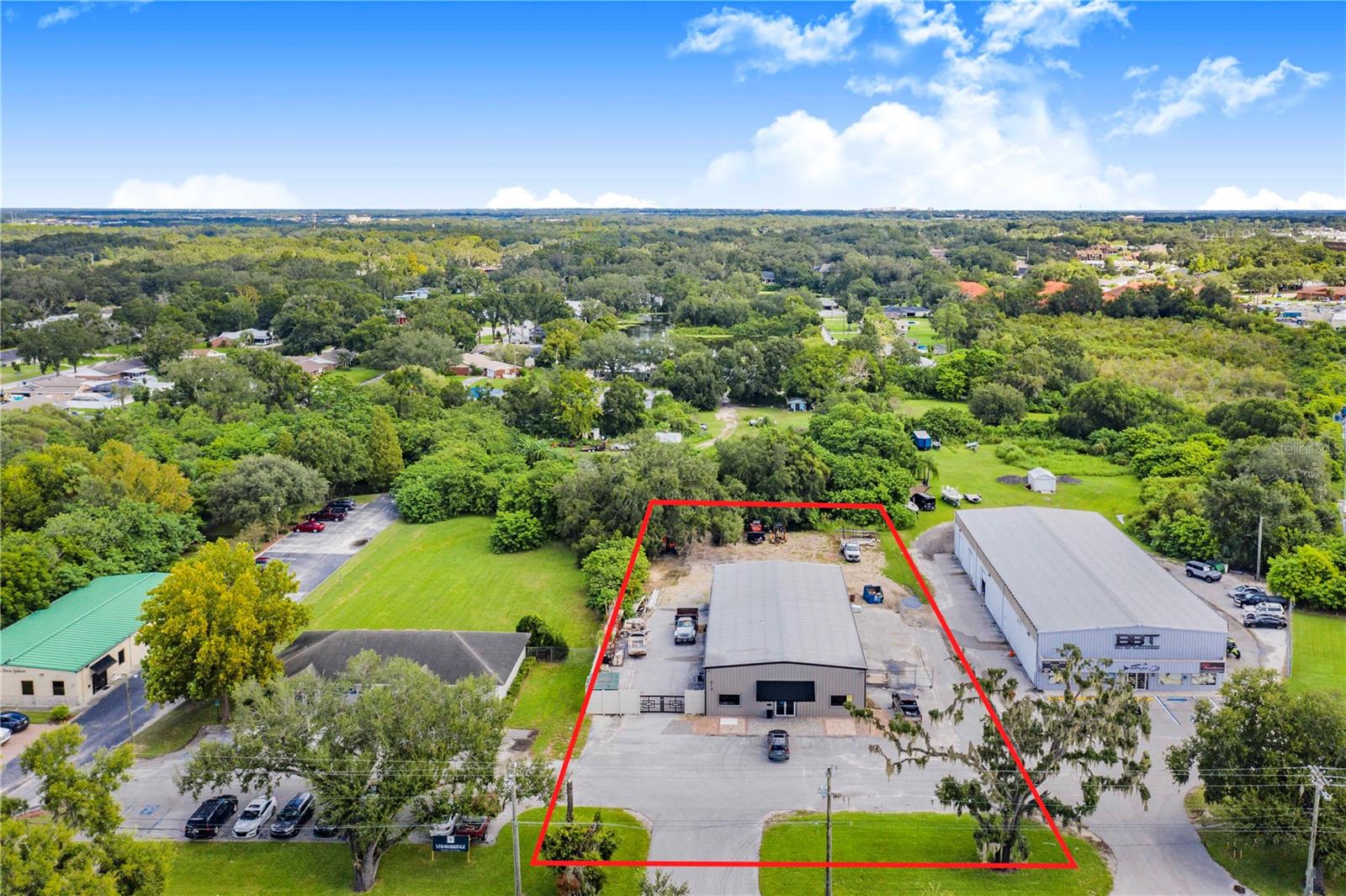 Spacious commercial warehouse in the heart of South Lakeland, featuring 1,700 sq. ft. of beautifully maintained showroom and office space and about 3,300 sq ft of warehouse space with drivethru bay doors. The front office area boasts a stylish, upscale design with two large private offices directly off the main showroom floor. The property includes two bathrooms—one in the office area and one in the warehouse. Four 12-foot roll-up doors provide easy access to all sections of the warehouse, with ample drive-through space for work trucks and customer vehicles. The exterior offers generous paved storage and work areas, with a fully fenced perimeter starting from the front of the building. Plenty of parking is available for both customers and employees. This property is an incredibly rare find, because it is located in the heart of south lakeland, with a full vehicle or laydown yard, ability for trucks to drive all the way around the building and its just minutes from the parkway and interstate. Perfectly situated for any business with the need for an accessible location for customers or employees with plenty of room to run a full scale business of all sorts. Buildings with office and warehouse space in this location with direct visual traffic from South Florida almost never come up for sale. Do not hesitate on this one as it will not last long! *Note: The business is NOT for sale, just the property and building.*. Property will be vacant at closing.
