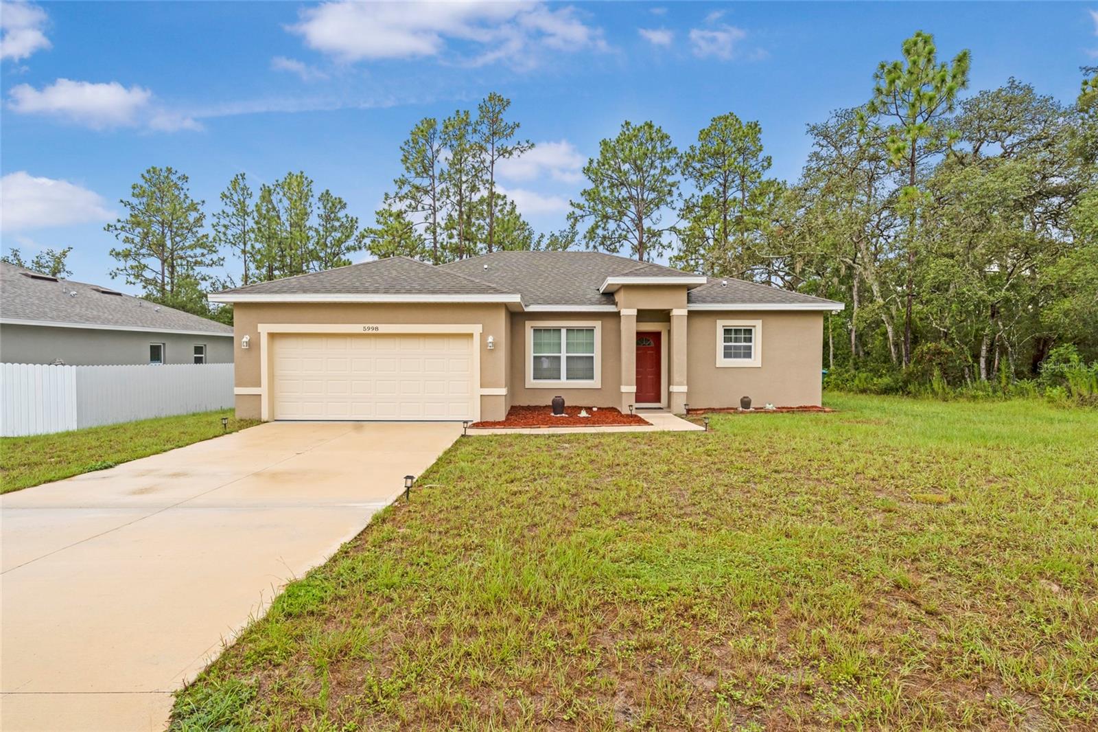 Seller motivated! Welcome to this four-bedroom and a two-and-a-half bath with a two-car garage! As you walk through the front door into the open floor plan, you feel warm and welcomed. With stainless steel appliances and stone countertops in the kitchen giving the home a modern feel. The large bedrooms offer plenty of room for furniture, so you don't feel cramped. Sit on the back porch that is surrounded by trees offering peace and privacy. The home is only two years old, so you don't have to worry about major repairs for several years, and obtaining insurance will be easy and affordable. This home would be a great investment in a growing community or perfect for anyone who would need plenty of space.