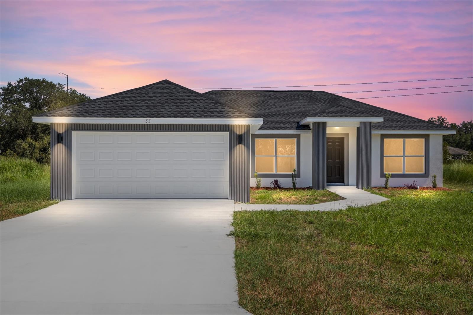 Under Construction. Country living at its finest! New home on an undeveloped road. Welcome to this stunning new construction “Fernand” Model by Bakan Homes. Offering 1,380 square feet of living space and a total footprint of 1,972 square feet, 8’ ceilings in the bedrooms and vaulted ceilings in the social areas, this home welcomes you with a sense of openness and comfort. The kitchen is a showstopper with striking Calacatta marble quartz countertops, a dramatic waterfall island, and sleek black fixtures throughout. The cohesive modern design continues into the bathrooms, featuring matching quartz vanities and a spa-inspired rainfall shower in the primary suite. Additional features include...luxury waterproof vinyl plank flooring throughout, contemporary LED light fixtures and ceiling fan in the living room, and a 12x12 covered lanai perfect for relaxing or entertaining. This home offers the perfect blend of style, functionality, and value. Don’t miss your opportunity to own a beautiful new build in a growing area of Ocala! Your investment is protected by a limited Builder Warranty that expires 1 year after the issuance of the Certificate of Occupancy. Pictures are of a recently completed model. Colors, finishes, and appliances may vary from home to home. Estimated completion dates are only an estimate and can be delayed due to unforeseen circumstances.