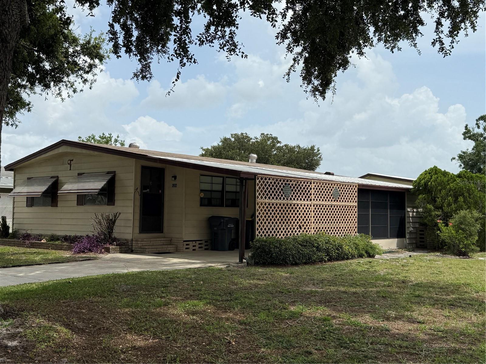 DON'T WAIT TO OWN THIS 2BR-2BA MFG HOME ON THIS LARGE CORNER LOT IN SE COMMUNITY WITH LOW MONTHLY FEES, OWNING YOUR OWN LAND AND GREAT AMENITIES. CLUBHOUSE WITH LARGE ENTERTAINMENT ROOM, FULL KITCHEN, LIBRARY, BILLIARDS ROOM,
SPA, OVERSIZED POOL OVERLOOKING WATERFRONT PEACE POND WITH COOKOUT ROOM OFF POOL AREA AND EVEN SHUFFLEBOARD, THIS COMMUNITY OFFERS SO MUCH FOR THEIR RESIDENTS. THE HOME IS MOVE IN READY AND HAS SOME FURNITURE LEFT FOR CONVENIENCE OF THE SELLER. OPEN LIVING ROOM DESIGN WITH SEPARATE DINING ROOM, LARGE KITCHEN HAS EAT IN COUNTER , SPLIT BEDROOM PLAN WITH 2 BATHS. PRIMARY BEDROOM AND BATH HAS STEP IN SHOWER AND GUEST BATH OFF 2ND BR HAS TUB. LAUNDRY ROOM WITH WASHER, DRYER & WORKSHOP WALL OFF THE 14X8 SCREEN ENCLOSED PORCH. 18X11 CARPORT WITH LONG DRIVEWAY WITH PLENTY OF PARKING SPACE FOR VISITING GUESTS. MATURE LANDSCAPING WITH 2 LARGE OAKS ON THIS CORNER LOT.