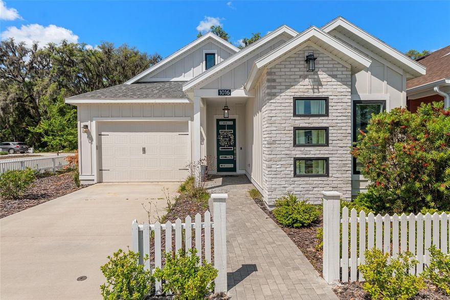 Welcome to this beautifully maintained Micheline III by Kara Bolton Homes in Fairway Pointe at West End, offering a thoughtfully designed 3-bedroom, 2-bath layout with a one and a half car garage, ideally positioned on a desirable corner lot. Step inside to a light-filled, open interior featuring wood-look luxury vinyl plank flooring throughout with NO carpet and soaring 10-foot ceilings paired with 8-foot doors that enhance the spacious feel. The kitchen is both stylish and functional, complete with quartz countertops, an undermount sink, solid wood cabinetry with soft-close drawers, and stainless-steel appliances including a built-in oven and microwave, gas cooktop with vented hood, and dishwasher. The living area is warm and inviting with a tray ceiling and glass doors that open to a covered lanai, creating the perfect indoor-outdoor flow for relaxing or entertaining. The primary suite offers a peaceful retreat with a large walk-in closet and a beautifully appointed bathroom featuring an oversized tiled shower and dual quartz vanities. Additional highlights include a tankless gas water heater, smart home features such as a doorbell camera and smart deadbolt, and thoughtfully designed exterior details including Hardie board siding, black-framed windows, decorative pavers, and lush Zoysia sod with irrigation. Enjoy low maintenance living with a low HOA of $125 that includes high speed COX internet and community amenities including a pool, tennis and pickleball courts and clubhouse. Steps away from Alachua Counties newest park that has over 3 miles of walking trails. Conveniently located just minutes from shopping, dining, and major medical facilities, including North Florida Regional, Shands, and the VA, as well as the University of Florida. Buyer to verify all school zones and measurements.