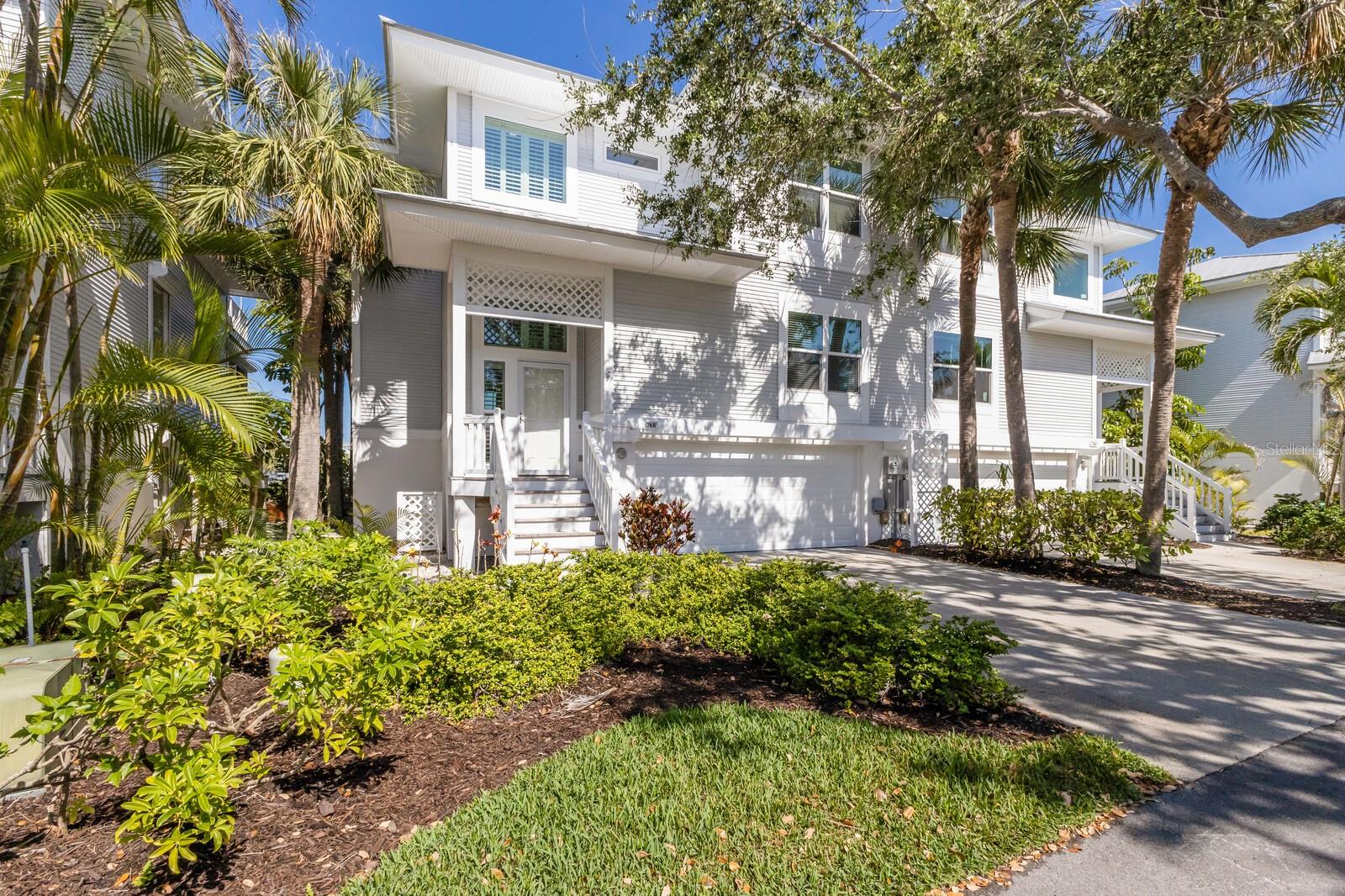 Under contract-accepting backup offers. One or more photo(s) has been virtually staged. This ideally located 3-bedroom, 3-bath Kentia townhome in Boca Bay’s South Village offers panoramic lake views with a desirable southwest exposure.
The main living area features an open layout with an updated kitchen, a gas stove, and a cozy built-in gas/electric fireplace in the living room. Electric Hunter Douglas blinds provide added convenience and comfort throughout the primary living spaces. An enclosed waterside porch off the living area extends the interior space, bringing in natural light and scenic lake views.
Upstairs, the top-floor primary suite opens to a private sun deck, where you can enjoy expansive lake views, spectacular sunsets, and a peek of the Gulf. A second outdoor space on the ground-level lakeside porch is perfect for grilling and relaxing by the water. Each bedroom includes its own en-suite bath, offering privacy and convenience for both owners and guests.
Additional features include an elevator servicing all three levels, a new 2024 A/C system, a 2022 metal roof, impact-rated windows and doors, and a spacious 3+ car garage with ample storage.
A short walk across a charming lake walkway with a picturesque gazebo leads to the main Boca Bay Pass Club, providing easy access to dining, fitness, tennis, and the beach. Residents also enjoy community amenities such as multiple swimming pools, pickleball courts, short-term boat dockage, a private fishing pier, and a Gulf-front Beach Club.
This townhome presents a wonderful opportunity to experience the best of Boca Grande living in a well-maintained, comfortable townhome.
