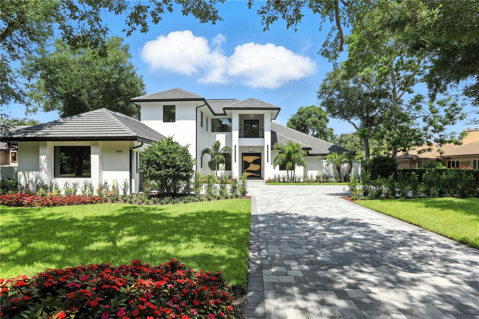 Experience luxury living at its finest in the high end gated community of Isleworth. Nestled on the 6th fairway of Isleworth’s world-renowned golf course, this beautifully redesigned estate offers over 6,900 square feet of exquisite living space, featuring 5 bedrooms and 6.5 bathrooms. Completely reimagined by renowned architect Mark Nasrallah, the home blends modern elegance with resort-style comfort. From the moment you arrive, you’re welcomed by a striking 10-foot-tall custom pivot door and an open-concept layout flooded with natural light and elegant design elements—truly an entertainer’s dream. The main living area features lavish, exotic flooring that is both elegant and inviting. A sleek, contemporary fireplace creates a stylish yet cozy setting for everyday living and entertaining. The chef’s kitchen is the heart of the home, complete with high-end appliances, custom European cabinetry, designer countertops, and an oversized island. A hidden pantry with a secondary prep area is ideal for hosting and everyday functionality. A temperature-controlled wine cellar adds an elegant touch of sophistication—perfect for showcasing and preserving your finest vintages. The spacious downstairs primary suite is a private retreat, where every detail goes above and beyond. From custom chandeliers and stunning LED lighting to a spa-inspired bathroom featuring an elegant soaking tub, a massive walk-in shower, and a tropical outdoor shower, this space feels like a luxury resort. The designer walk-in closet is sure to impress with its custom lighting and exquisite finishes. A versatile bonus room off the suite offers endless possibilities and opens directly to the stunning pool deck overlooking the golf course. A massive sliding glass door allows for a seamless indoor-outdoor living experience, making entertaining effortless and luxurious. Nearby, a private office features floor-to-ceiling glass, built-in cabinetry, refined finishes, and abundant natural light—creating a bright and inspiring workspace. As you ascend the custom floating staircase, you’re greeted by lush built-in planters below, evoking a tranquil island-inspired ambiance. The upper level continues to impress with a secondary primary suite, complete with a luxurious bathroom and spacious walk-in closet. Another upstairs bedroom includes its own en-suite bathroom and walk-in closet. The expansive game room is perfect for family fun or entertaining guests and opens to a grand balcony with panoramic golf course views. The home theater is modern and inviting, showcasing custom LED lighting, two-tiered seating, and state-of-the-art sound for a true cinematic experience. Step outside to your personal oasis—featuring a sleek pool with a heated spa, surround sound throughout the exterior, an outdoor kitchen, wet bar, and lush, professionally designed landscaping. This smart home is fully integrated with a Crestron system that controls lighting, security, audio, climate, and more—all at your fingertips. For added peace of mind, the property is equipped with a backup generator to ensure uninterrupted comfort. Located in one of Central Florida’s most exclusive communities, this property offers not only unmatched amenities and top-tier finishes, but also an extraordinary lifestyle of luxury and leisure. Contact us today to schedule your private tour and experience the pinnacle of Isleworth living.