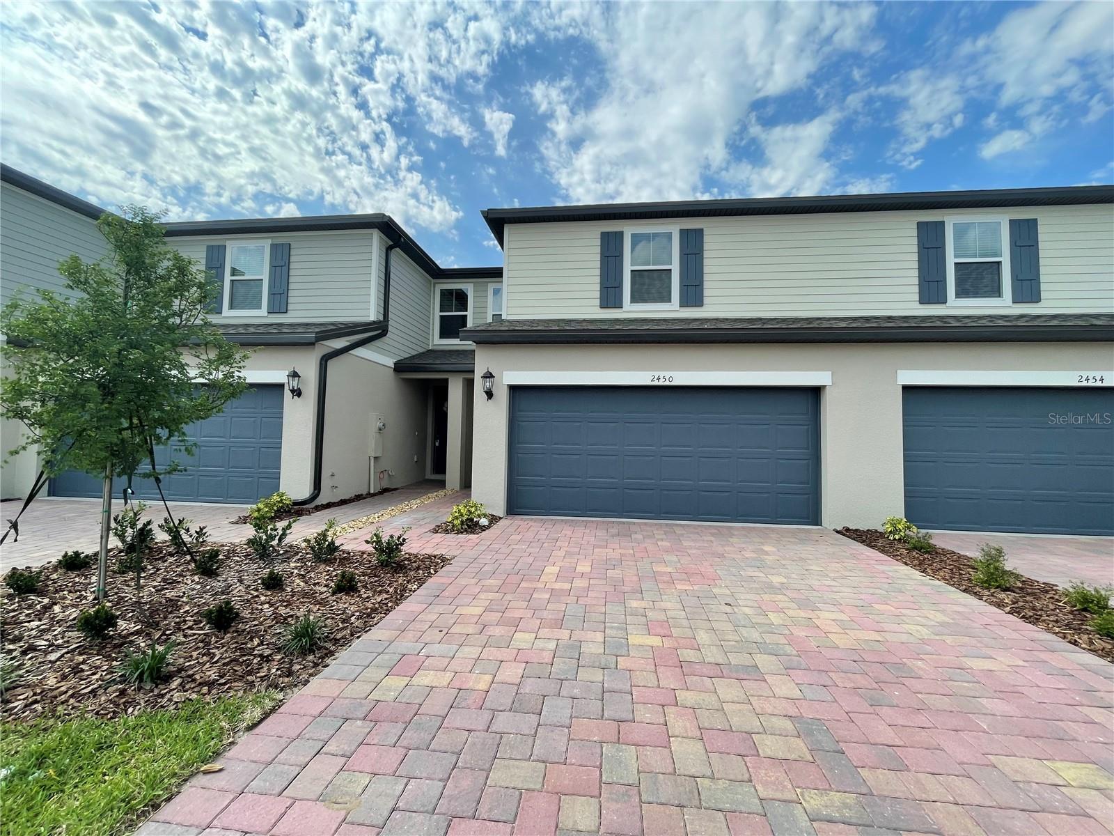 2450 Sweet Viburnum Way is a 3 bedroom, 2.5 bath town home located in Ocoee. As soon as you enter into the home, you're welcomed into the spacious kitchen overlooking the living and dining area. You'll notice plenty of natural daylight through the multiple windows and sliding glass door leading through the living room to your back patio. The kitchen has a full suite of stainless steel appliances including refrigerator, range, over the range microwave and dishwasher as well as plenty of cabinet and counter top space. The downstairs guest bathroom is easily accessible from the living area. Continuing upstairs, the master suite is located separate from both additional bedrooms and has a spacious walk in closet. The master has private access to the master bathroom, with a glass enclosed standing shower and dual sinks. Both additional bedrooms are well sized and are connected by the jack and jill bathroom which features a shower tub combo. Rounding out this home is the upstairs laundry area which features hookups to accommodate for a full sized washer dryer and the 2 car garage. This beautiful home will not last long!