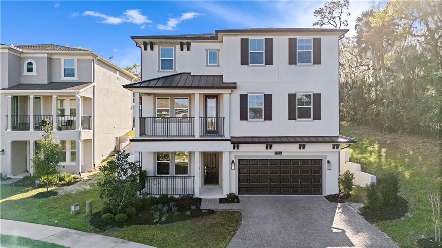 The kind of home buyers hope to find but rarely do-over 4,000 sq ft of thoughtfully designed living space, flexible rooms for today's lifestyle, and the rare advantage of a FOUR-CAR GARAGE. Built in 2021 and located in the Dora Parc Community, this beautifully designed home blends architectural charm with modern functionality in one of Central Florida's most beloved lakefront town.

The welcoming COVERED FRONT PORCH and BALCONY create an inviting first impression and set the tone for the warm and comfortable spaces found throughout the home. 
Some pictures are virtually staged.

Just inside the entry, you'll find a PRIVATE GUEST- IN-LAW SUITE featuring a built-in Murphy bed and full bathroom, providing the perfect space for extended family, visiting guests, or a quiet work from home retreat.

At the heart of the home is a stunning CHEF'S KITCHEN featuring an oversized island, stone countertops, gas range, designer lighting, extensive cabinetry, and walk-in pantry. The expansive island offers abundant prep space and seating, making it the natural gathering place for the family and friends. A custom accent wall with the floating shelves adds warmth and distinctive designs rarely found in newer homes.

The open layout flows seamlessly into the dining and living areas, creating an ideal setting for everyday living and entertaining. French doors from the dining area open to the front balcony, offering the perfect spot for morning coffee or evening relaxation.

One of the home's standout features is the EXPANSIVE DOWNSTAIRS FLEX SPACE, offering exceptional versatility. Whether used as a MEDIA ROOM, GAME ROOM,HOMESCHOOL AREA, FITNESS STUDIO, OR second family room, The possibilities are endless.

Upstairs, the spacious Primary suite serves as a true retreat, Featuring tray ceilings detail, abundant natural light, and generous proportions. The spa-inspired primary bath includes dual vanities, a soaking tub positioned beneath a sun-filled window, a separate shower, and ample space to unwind.

Outdoor living is equally inviting with a large covered lanai overlooking a deep backyard with mature trees and added privacy.  Unlike many newer homes, the natural tree line behind the property creates a peaceful backdrop and room to relax, entertain, or plan for a future pool.

One of the home's most valuable and rare features is the four car garage - A highly sought-after feature in Mount Dora where boating, fishing, and lake recreation are part of everyday life.  With the Harris chain of lakes just minutes away, the additional garage space is ideal for boats, golf carts, paddleboards, Kayaks or Hobby storage.

Located in Dora Parc, this home is approximately one mile from historic downtown mt Dora, Allowing you to walk or bike to charming boutiques, waterfront parks, award-winning restaurants, art festivals and year-round community events.

If you.ve been searching for a home that offers Space, flexibility, architectural character, and walkable access to downtown Mt. Dora, This property truly stands apart.