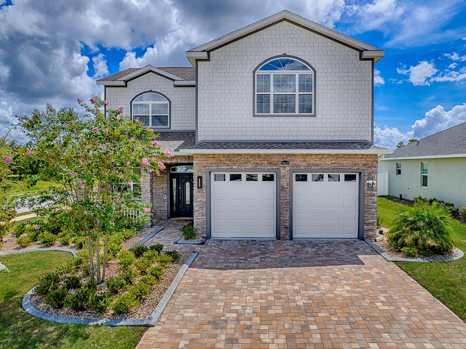 STUNNING HOME! TERRIFIC LOCATION! QUALITY CONSTRUCTION! This 2 Story - 4 Bedroom, 2 1/2 Bath home sits on a Corner Lot with Room for a Pool in the FAMILY FRIENDLY NEIGHBORHOOD OF DENSAN PARK! Impressive & Stylish Curb Appeal with a Paver Drive & Walkway, Covered Front Porch, Stone Accented Front & a Decorative Front Door with Sidelites and Transom Window! The LIGHT, BRIGHT & SPACIOUS Interior Delivers 'WOW FACTOR' - 10' Ceilings, Crown Molding, Porcelain 'Wood-look' Tile Flooring, Lots of Windows, etc.... The Open Concept Floorplan showcases a central Kitchen with Large Center Island, Plenty of Cabinets, Quartz Counters & Complimentary Backsplash, Upgraded Stainless Appliances (Gas Range) and a Closet Pantry - all seamlessly connecting to Living and Dining areas. The Large Laundry Room has extra storage cabinets and there is a 1/2 Bath conveniently located off the kitchen. All Four Bedrooms are located on the second floor. The Primary Bedroom has an Organized Walk-in Closet and EnSuite Luxury Bath with Dual Sinks and Walk-in Shower. The Secondary Bedrooms share a Hall Bath with a Tiled Tub/Shower combo. The home also features a Covered Lanai equipped with a Summer Kitchen - Grill, Sink & Mini Refrigerator!! Additional Items You Will Appreciate: Nest AC Thermostat, Ring Doorbell, Tankless Water Heater, Upgraded Light Fixtures, Etc... Existing Amenities and/or Amenities to come: Tennis Courts, Playground, Basketball Courts, Volleyball, Fitness Trail/Exercise Stations, Dog Park, Picnic Areas! This Gated 'Family Friendly' Community is located just minutes away from shopping, restaurants, medical, VA, The Villages Charter School and The Villages Town Squares! TRULY A PERFECT PLACE TO CALL HOME!