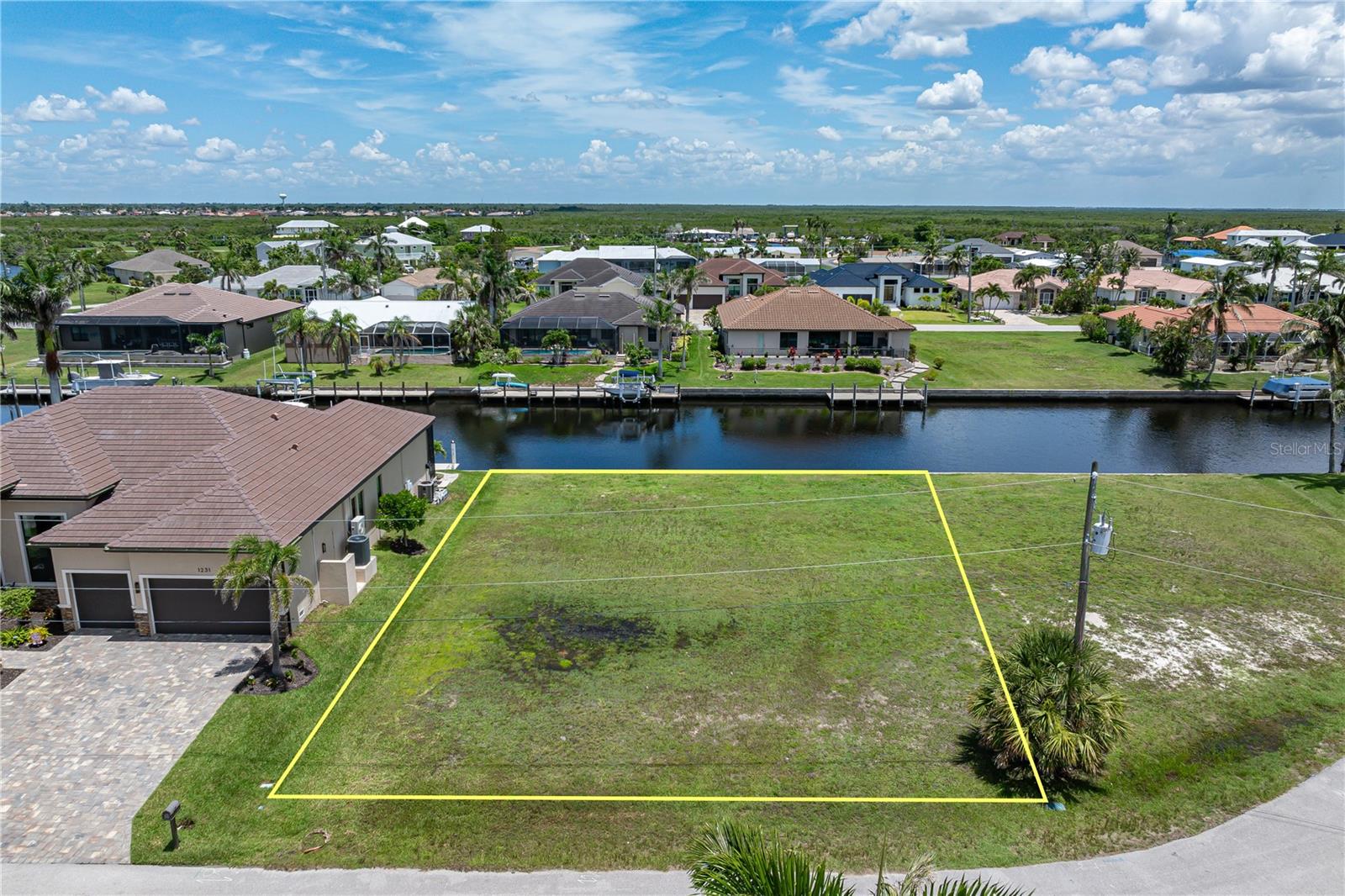 SAIL ACCESS LOT W/80FT SEAWALL IN PUNTA GORDA ISLES Prime waterfront opportunity! This build-ready, vacant lot in Punta Gorda Isles offers 80 feet of city-maintained concrete seawall and immediate sailboat access to Charlotte Harbor—no bridges, no delays. Located on a quiet, double cul-de-sac street, this full-size lot is surrounded by custom-built homes and ready for your custom, dream home. Enjoy a southeastern rear exposure with colorful sunrises and abundant natural light across your future lanai or outdoor living area. With the opening of Buckley’s Pass in 2020, you can now reach open water in under 15 minutes. City water and sewer are available. Enjoy a wonderful, wide canal view while watching boats pass by throughout the day. Now's your chance to own a premium sail-access lot in PGI — ideal for avid boaters and those ready to build in a well-established waterfront community. Don't miss your opportunity to claim your place in paradise.