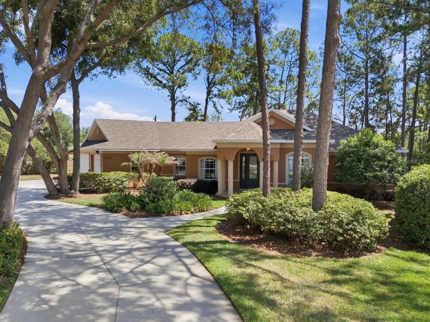 Tucked away within the gated community of Loch Leven, this thoughtfully updated 4-bedroom, 2.5-bath plus office residence offers over 2,300 square feet of beautifully designed living complemented by a tranquil outdoor oasis. A peaceful canal borders the rear of the property, while mature trees and lush landscaping enhance the serene setting.

Designed for both comfort and functionality, the split floor plan showcases refined living spaces accented by tasteful contemporary finishes. The spacious family room centers around a reimagined media wall with vertical wood slat detailing and recessed niches, adding warmth, texture, and architectural interest to the space.

The renovated kitchen blends contemporary styling with everyday convenience, offering quartz countertops, an expanded center island, 42-inch cabinetry, glass tile backsplash, upgraded fixtures, and a suite of Samsung Bespoke appliances. Additional improvements include a completely remodeled primary bath, contemporary lighting, hardwood flooring in the secondary bedrooms, an interior paint refresh, and a stylish frosted glass office entry, creating the ideal work-from-home setting.

The primary suite offers direct access to the lanai and pool area, while the completely remodeled spa-inspired bath delivers a luxurious retreat with boutique-style illuminated wardrobe storage, a floating dual vessel vanity, large-format porcelain tile, framed mirrors, pendant sconces, glass-enclosed shower, and a separate water closet.

Outdoor living is equally impressive with an expansive screened lanai overlooking the oversized backyard and canal, an inviting pool and spa, grilling area, and generous covered entertaining spaces.

Additional home upgrades include a 2022 roof, newer Rheem 80-gallon commercial-grade water heater, upgraded exterior lighting, Eufy digital entry system, and outdoor grill.

Residents of Loch Leven enjoy an elevated lifestyle surrounded by nature and centered around a private 160+ acre spring-fed lake offering boating, fishing, and more. Community amenities encompass a private dock, tennis and pickleball courts, basketball court, playground, trails, optional RV and boat storage, golf cart-friendly streets, gated entry, and convenient access to major highways, grocery stores, and the charming shops, waterfront parks, dining, and year-round festivals of downtown Mount Dora.

Don’t miss this opportunity. Schedule your private showing today!