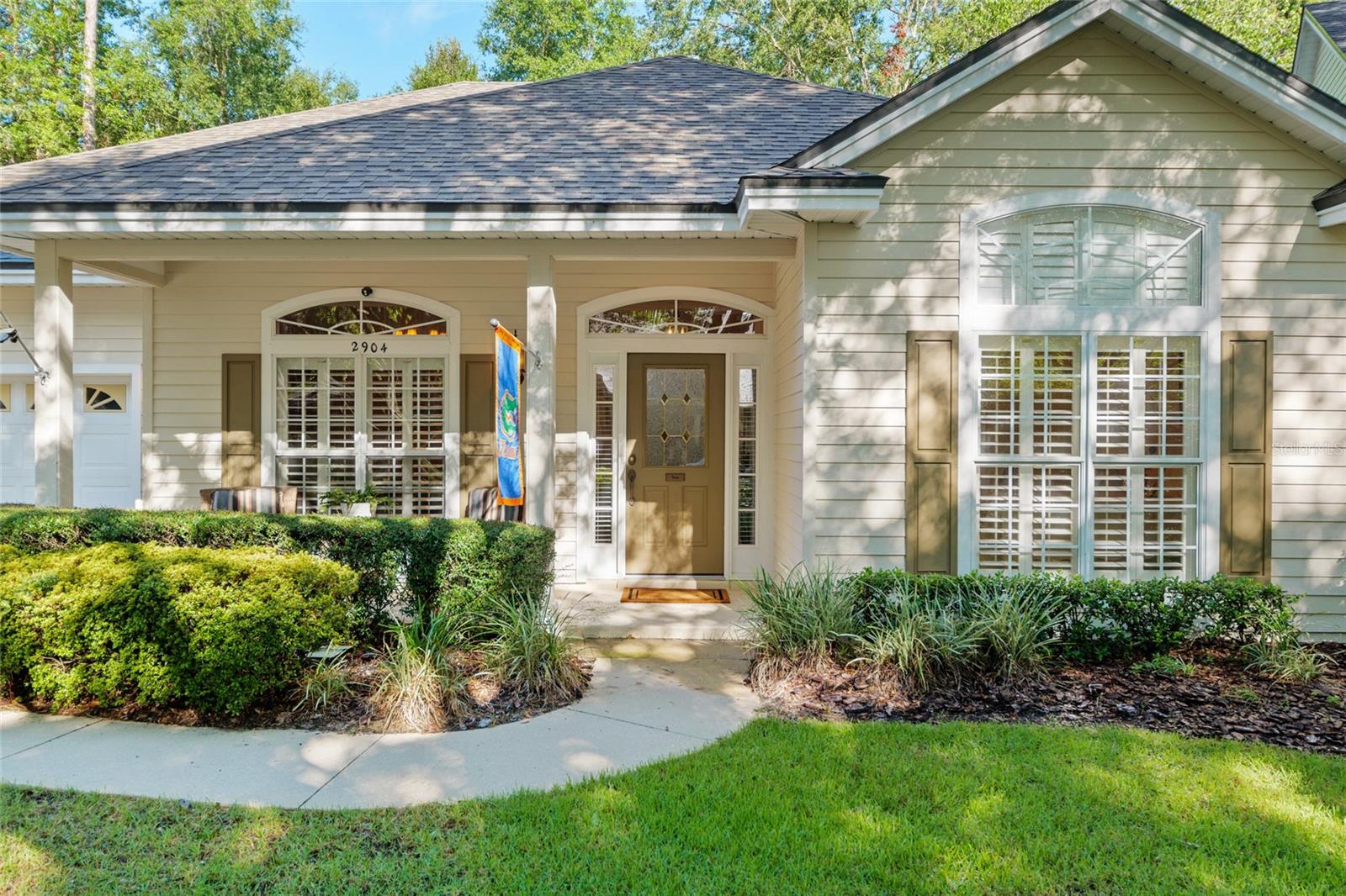 This darling Paul McArthur built home in Haile Plantation’s Victoria Circle is one of two-dozen homes in this tree-lined subdivision. This popular 3-way split floor plan with 2288 SF features 4 bedrooms and 3 baths. The builder’s vision for Victoria Circle was the iconic symbol of relaxation and hospitality – the front porch which complements the outdoor living space of this home. Inside the foyer opens to the formal dining space on the left. Use this room for dining, or close off its direct access to the kitchen for a separate home office. The first guest wing is on the right. Close the hallway access door for your guest’s privacy. Best features include east-facing windows and a vaulted ceiling in the bedroom, and a linen closet outside the hallway bath. A little farther down the entrance hallway you will notice the home opening to the kitchen, family room and nook. The kitchen features white wood cabinetry with soft-close drawers topped with quartz counters. There is a separate pantry within the kitchen, and a secondary pantry next to the laundry room entrance. Additional features include most appliances replaced in 2021 and a raised breakfast bar for casual seating. Beyond the kitchen is the nook and family room, all connected by hardwood flooring. The nook is generous in size. The family room has a remote-controlled gas corner fireplace with wood mantle as its focal point. Both the nook and family room overlook the rear screened porch and backyard. To the right of the family room is the hallway for the second and third guest bedrooms, and second guest bath. Across the family room from this guest hallway is the master suite. The spacious walk-in closet is separate from the master bedroom en suite bath. The screened rear porch can be accessed from the master bedroom and the family room via French doors. The outdoor living space of this home is very inviting, and perfectly set up for casual living and informal entertaining. Connected by concrete pavers, the rear yard features an area for a firepit surrounded by Adirondack chairs. The custom stacked stone fireplace creates an outdoor living space with its wood burning, rectangular fire box opening with a fully-functioning chimney. Flanking the firebox are shelves for your stacked wood. Behind the fireplace are two storage containers for the outdoor furniture cushions when not in use. The entire yard is fully fenced. Additional home features include Plantation shutters, wood flooring, custom built-ins, chair rail and crown molding, an interior laundry room with washer and dryer, a front yard sprinkler system, and a 2022 architectural shingle roof. This home’s location can’t be beat – less than a 2-minute walk to Chiles Elementary and a 3-minute car ride to the Publix Market Square. Enjoy the epitome of convenience with the Hawkstone Country Club just 4 minutes away, where, with membership, you can enjoy two pools, dining privileges, fitness center and the 18-hole Gary Player golf course. Haile is also an approved golf cart community, so hop on your golf cart to head to the Club or toward the Village Center for coffee, cupcakes, shopping, dining or for browsing the Saturday Farmers’ Market. Haile residents have access to 13+ miles of paved walking and jogging trails, most of which is naturally shaded for year-round use, and which interconnect the entire community. Once you experience the Haile lifestyle, you’ll understand why this is one of Gainesville’s most sought-after communities
