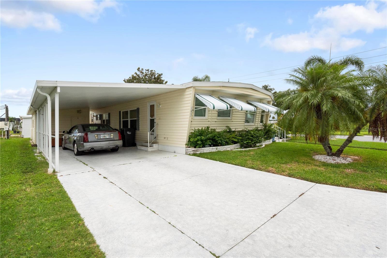 Welcome to this inviting 2-bedroom, 2-bathroom doublewide manufactured home set on a desirable land-owned corner lot in the sought-after Heather Hills community. With 1,248 sq. ft. of comfortable living space, this residence blends modern updates with a relaxed Florida lifestyle. Property highlights are, a spacious open layout with an updated kitchen and dining room, luxury vinyl flooring in kitchen, dining, and baths, carpet in living & bedrooms for comfort, plywood subflooring, drywall ceilings, and freshly painted paneling for a clean, modern feel. This home has a new roof for peace of mind. The main suite has a walk-in closet & en suite shower bath. The guest bath is large with an updated linen closet and tub/shower combo. There's a heat pump HVAC for efficient year-round comfort. The lanai has been converted to a spacious deck—perfect for morning coffee or evening relaxation. The laundry is located in the large storage shed at back of carport. Heather Hills welcomes your small furry friend in this very friendly pet community. Residents enjoy the optional HOA membership, water billed quarterly, and a vibrant community featuring a clubhouse & library, shuffleboard courts, BBQ grills & picnic tables for social gatherings. Just 8 miles from world-famous Anna Maria Island, you’ll have easy access to sandy beaches, local dining, shopping, and everything Bradenton/Sarasota has to experience. Currently the home is occupied with a long-term renter who wishes to stay—ideal for investors looking for immediate rental income. Don’t miss your chance to own a low-maintenance, move-in ready home in one of Bradenton’s most welcoming communities. Whether you’re looking for a personal retreat, seasonal escape, or smart investment, this home checks all the boxes!