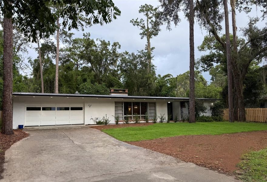 ocated just 0.9 miles away from UNIVERSITY of FL.  Home is perfect for UF STUDENTS, ALUMNI & Affiliates who want to stay close to campus…only a 10 minute walk. Highly Coveted Neighborhood. Home has Incredible OPEN FEEL around the Kitchen with three Large Living Areas; Living Room, Dining Area, and Family Room.  The Architecture feels Eichler Style with LARGE VAULTED CEILING. 
Home has almost a Half Acre Lot while the Large Backyard area is ideal for outdoor BBQ’s, Activities and Entertaining.  NEW ROOF July 2025.  Newer A/C 2024. The Huge 2 Car Garage provides Ample Storage & Parking, Featuring an Extra Long Double Driveway, with Extra Front Drive Access. The property sits in a Convenient Location with easy access to almost all retail conveniences like Publix, Home Goods, Schools.   Just a 2 minute Walk to a Very Nice Park.   Seller may be open to a Lease Option to Buy or Seller Financing.   Room Measurements are Approximate.   Call to Set Appointment to View.