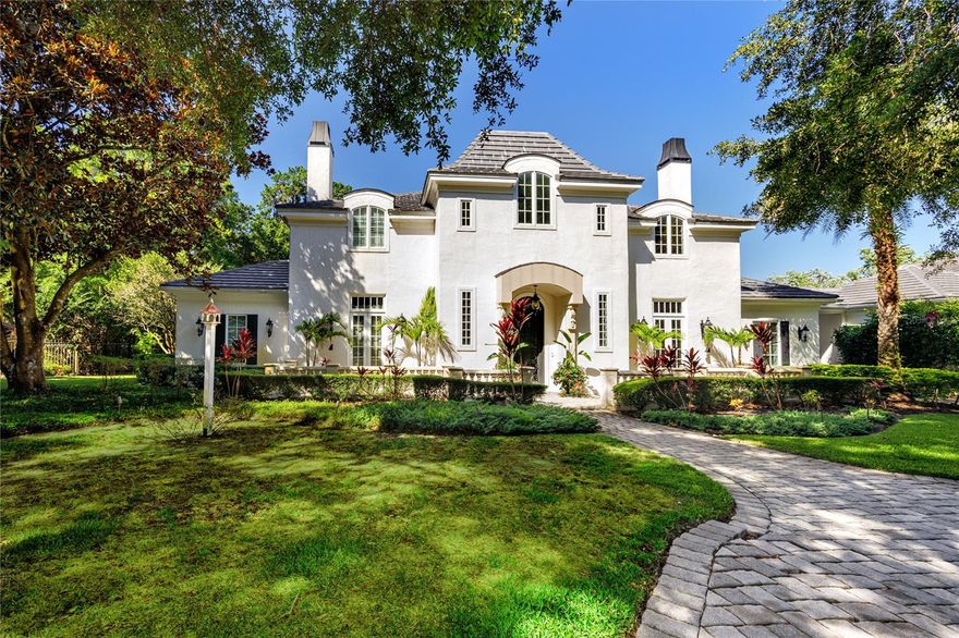 Welcome to "Maison de la Vie," a stunning 5,896 sq. ft. French Manor Estate set on a spectacular 1.5-acre conservation lot in the prestigious, guard-gated luxury community of Stillwater. Built by the renowned Bayfair Builders, this exquisite residence showcases unparalleled quality, old-world craftsmanship, and exceptional attention to detail. Upon arrival, you'll be greeted by a grand circular driveway leading to a European-inspired motor court with four-car garages with porte-cochere access to the mudroom. Inside, elegance abounds with features including. The formal entrance is graced by an iron-inset glass door, complemented by a magnificent chandelier and a grand stairway with two landings. A sophisticated library/office complete with a fireplace and mahogany cabinetry. An expansive chef's kitchen boasting three ovens, a six-burner professional gas range, an 8' x 5' island with a prep sink, and a large walk-in pantry. Perfect for wine enthusiasts climate-controlled wine room. A fabulous first-floor master suite featuring an adjoining exercise room, a massive walk-in closet, and a luxurious master bath. A grand two-story foyer and a magnificent baronial dining room with a beamed and coffered ceiling. A sun-filled family room with a fireplace, a wine room, and a game or billiard room with a bar, adjacent to a cozy 10' x 19' loft area. An expansive lanai with a saltwater pool and spa, overlooking a private tropical paradise. Upstairs, you'll find four spacious bedrooms. The fifth bedroom is currently used as a private home office, ideal for working from home. "Maison de la Vie" is an architectural gem, offering a compelling value in a community of multi-million dollar homes. This home is a testament to unparalleled craftsmanship and luxurious living. Residents enjoy access to a clubhouse, pool, tennis court, playground, and a football and soccer field. The location provides quick access to the Veterans Expressway, area shopping, excellent schools, and the Tampa Bay Trail. This is the home you've been waiting for. Come experience the luxury and elegance of "Maison de la Vie."