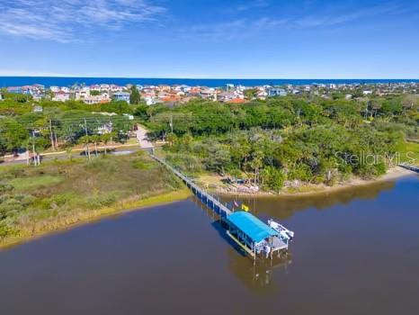 Coastal Luxury Meets Everyday Freedom! Imagine waking up just five minutes from the beach, stepping out onto your private lanai with coffee in hand, and watching the sun glisten off the Halifax River. This isn’t a vacation—it’s your everyday reality in this elevated, energy-smart estate tucked away on over an acre of pristine, high and dry land in a no-flood zone. Thoughtfully designed for both serenity and celebration, this 3-bedroom, 3-bathroom home (plus a dedicated office that easily converts to a 4th bedroom) offers timeless style and modern peace of mind—with solar power, a whole-house generator, and custom touches throughout. From triple tray ceilings and architectural columns to triple-stacked doors that open fully to the resort-style pool, every detail enhances the flow between indoor elegance and outdoor escape. Entertain effortlessly from your chef’s kitchen, outfitted with double ovens, an island stovetop, and custom hardwood cabinetry. Host intimate gatherings in the cozy fireside sitting room or escape to your oversized primary suite with tranquil pool views, double custom closets, a concrete-reinforced safe room, and a spa-worthy en-suite bath with a freestanding tub and walk-in shower. Outside, your private dock stretches 235 feet into the river, complete with new electric and dual boat lifts (6,000 & 10,000 lbs)—ready for your spontaneous sunset cruises or morning fishing runs. The lush, palm-lined landscape is illuminated at night with a color-changing light package, while a 50-amp RV pad ensures room for guests or your next great adventure. This is more than a home—it’s a lifestyle. Solar-powered, storm-ready, water-connected, and beach-close… all that’s missing is you.
Schedule your private tour today, and ask for the full features list—because the best parts are even better in person.