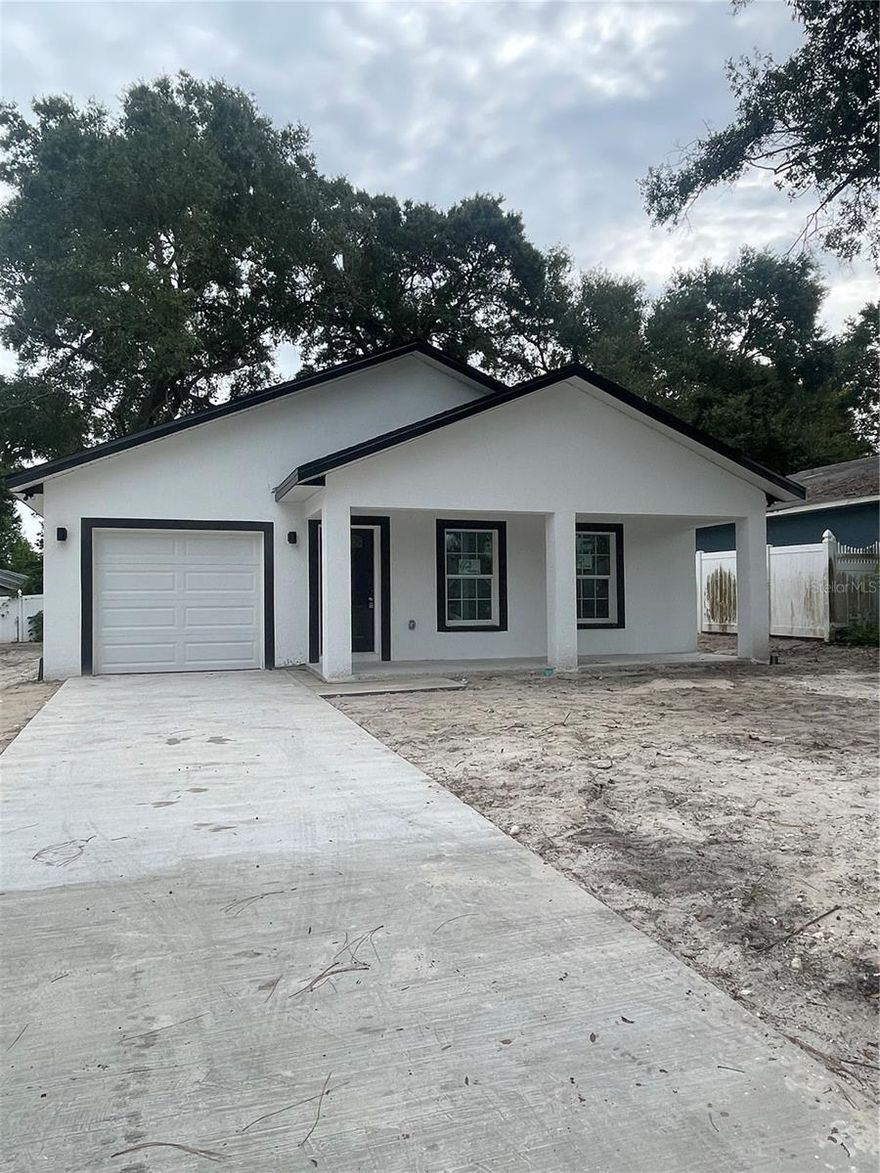 Under Construction. Own a brand NEW home for less than rent in the heart of Tampa. This new construction property will be completed in October 2023. It features an open concept floor plan with 3 bedrooms & 2 full bathrooms complete with an attached 1 car garage. Entertaining will be a breeze with the spacious living/dining area showcasing cathedral ceilings and luxury vinyl flooring. You will fall in love with the gourmet kitchen featuring 42" solid shaker cabinets with crown molding, granite counters & a SS kitchen appliance package. The master bedroom features an en-suite bathroom and HUGE walk in closet. Host the ultimate cookouts in your spacious & private yard. No HOA or flood zone! Enjoy benefits such as lower insurance and energy efficiency savings that come with purchasing a new home. You will also receive a 2-10 builders home warranty at closing. Conveniently located near USF, Busch Gardens, and close to downtown Tampa.  Ask how you can move into this property for ZERO dollars down. Come see why this is a great place to call home! *Photos are of a similar, completed home*