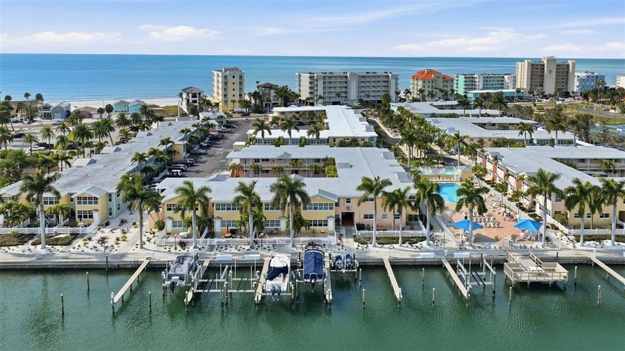 One or more photo(s) has been virtually staged. ***Investor special—no nightly minimum,*** highly profitable short-term rental with BOAT SLIP AND LIFT***, income statements can be provided. This unit boasts an exceptional rental history—it is the most booked unit in the entire complex, offering a proven income-producing opportunity.

Welcome to Barefoot Beach Resort, a hidden gem in the charming coastal town of Indian Shores. This investor special is a hidden gem in the Airbnb short-term rental community. This unit comes with its own personal boat slip and lift right in the back of your unit, setting it apart in the short-term and long-term rental market. The property boasts a brand-new pool, plus this unit has brand-new air conditioning, plumbing, appliances, and all new electrical—inspected and permitted. With the perfect balance of rental potential and personal use, this turnkey investment is ideal for anyone adding to their portfolio or starting out. Nestled in the heart of Indian Shores Beach—truly Old Florida charm—you’re just steps from the beach, a private fishing pier, putt-putt golf, and iconic restaurants like Salt Rock Gril. This quaint seaside community offers the perfect balance of tranquility and accessibility—just minutes from Tampa, Clearwater Beach, and St. Pete Beach, allowing you to enjoy world-class dining, shopping, and entertainment while still retreating to your own peaceful waterfront escape.

Perfectly positioned between the Gulf of Mexico and the Intracoastal Waterway, this resort-style community truly surrounds you with water and captures the essence of “Old Florida” charm with lush native landscaping and a relaxed, coastal atmosphere. This rare corner unit offers stunning Intracoastal views and direct access from your back doors to the pool and patio area—complete with lounge chairs for soaking in the Florida sunshine. The community is designed for effortless coastal living, featuring:Heated waterfront pool, Multiple gas grills for outdoor entertaining, Private fishing dock with water and electric, and Steps to the Gulf beaches. Inside, the 2-bedroom residence is offered fully furnished and turnkey, making it ideal for immediate enjoyment or continued rental income. With on-site rental management, ownership is truly effortless—allowing you to enjoy consistent revenue while professionals handle the day-to-day operations. Whether you’re looking for a personal coastal retreat, an investment property, or both—this is a rare opportunity to own one of the most desirable units in the community. Life truly is better at the beach… and it doesn’t get better than Barefoot Beach Resort.