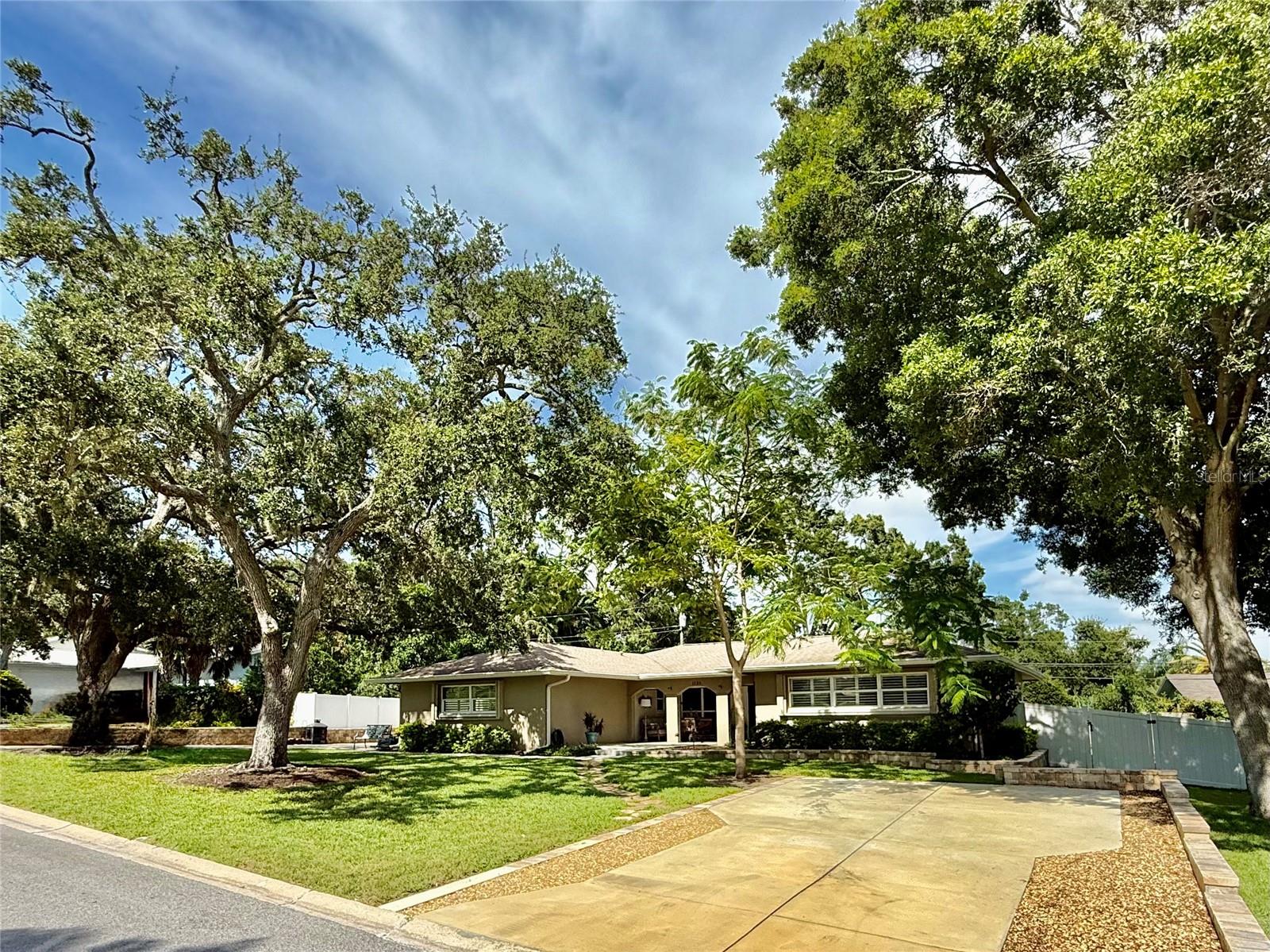 Don't miss this exceptionally upgraded solid block single-family home. Nestled on
a large lot, only minutes from Indian Rocks Beach, Tampa International Airport,
shopping, and world-class restaurants, this is where you want to be. The main
driveway leads to the generously sized 2-car garage. Double fence gates allow for
a boat or RV to enter the side yard of the home (short drive to the Belleair
causeway boat ramp). There is also a separate driveway on the right side of the
house. No storm worries here, high and dry with easy-close hurricane shutters on
all windows and doors. As you step onto the large, covered front porch and into the
welcoming entrance foyer, you are greeted by an open floor plan with plenty of
light. Immediately, you will realize no expense was spared to create this
masterpiece of a home. Enjoy entertaining guests in your formal living room and
dining room. Create gourmet meals in your Chef's design kitchen, featuring top-of-
the-line, stainless steel appliances, a built-in oven with microwave, a separate oven
and cook-top in the huge island, a French door fridge, and a built-in dishwasher.
"Truly awesome" best describes the "Maplewood" style soft-close cabinetry,
including 2 pantries and a dry bar. An abundance of granite counter space and
plenty of cabinets await in this beautifully designed service area. Siding doors lead
to a spacious patio where outdoor life comes alive. Create memories as your family
gathers for game night or a movie in the open family room. Warm wood-look
plank-style porcelain tile floors flow throughout. The master en-suite is spacious
and features a bath with a granite vanity top, double undermount sinks, an
oversized tile shower (built for easy access) with an open solid glass entry.
Additionally, the master en-suite offers a walk-in closet with loads of space. The
home has 2 more spacious bedrooms, each with ample closet space. The second
bath has double vanity sinks with a granite countertop. This home has two hall
closets providing plenty of storage space, with a laundry room leading to the
garage. Custom window treatments and plantation shutters complete the offering.