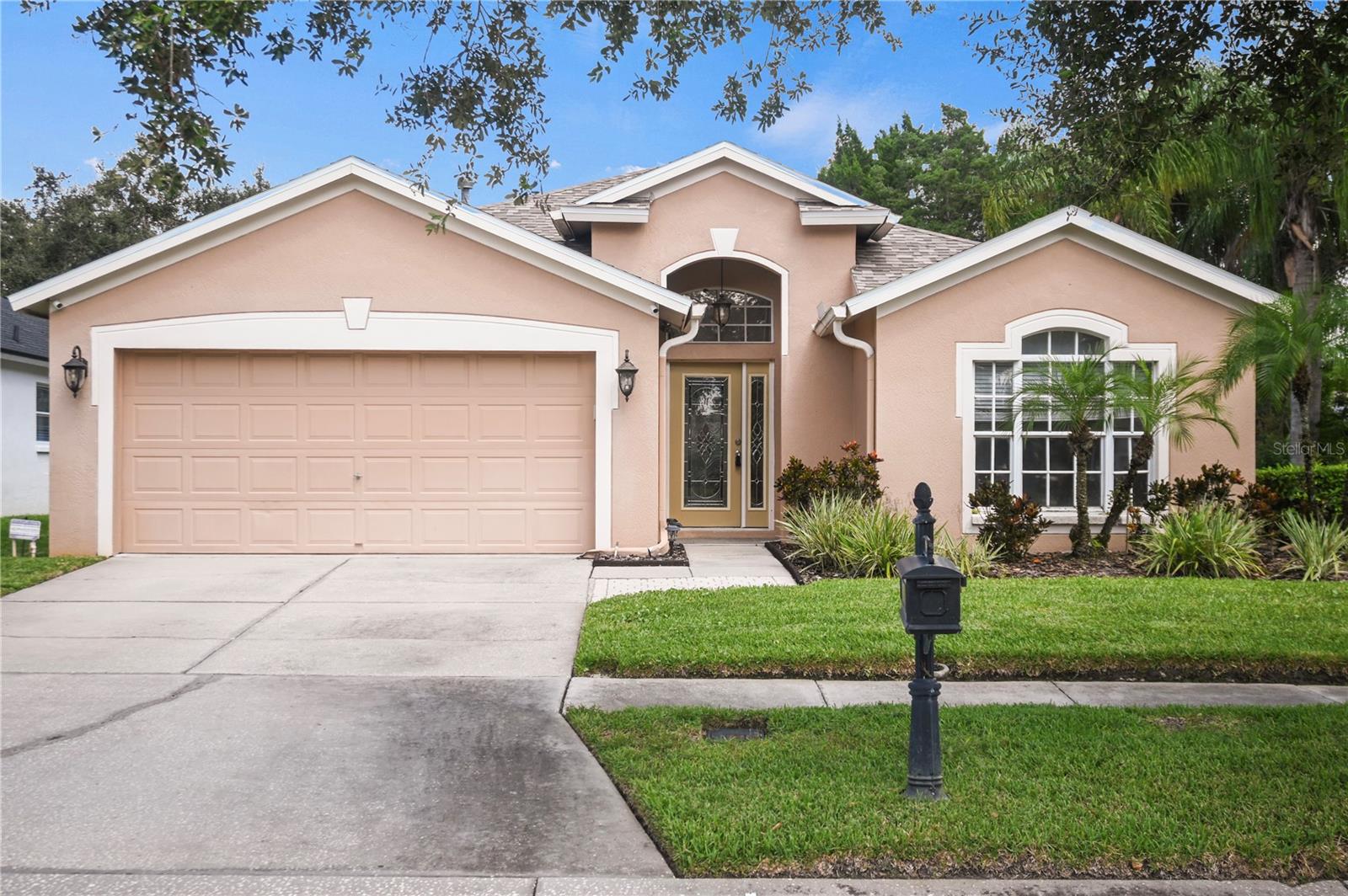 Beautiful 4 bedroom 2 bathroom 2 car garage corner lot Home in the Westchase area of Tampa, The mature landscaping is so inviting. Beautiful dramatic entrance as you walk through the lead glass door, with custom Travertine flooring and drop chandelier to greet you. Vaulted ceilings, architectural details galore, and custom light fixtures throughout add elegance to this open, spacious floor plan. Recessed lighting and tons of natural light to brighten your day! The gourmet kitchen features custom cabinets with crown molding, granite counters, decorative backsplash, built-in desk, and breakfast bar with room for seating. Stainless steel kitchen appliances include glass-top range, French door refrigerator with ice and water dispenser, microwave, and dishwasher. Pantry and linen closet keeps your essentials organized. Master bedroom features 2 walk-in closets with custom shelves and a full bath for privacy. The master bathroom boasts a custom double-vanity & sinks with granite counter top, garden tub, and walk-in shower. Carpet in the secondary bedrooms adds warmth and is so comfy on your feet. Ceiling fans will be sending you a cool breeze. Efficient central AC and heat will keep you comfy year round. Laundery room with washer and dryer CONNECTIONS for your convenience. Water softener is gentle on your clothes! Window blinds allow just the right amount of light. HUGE screen-enclosed paved patio, Convenient to Baybridge Park, Veterans Expy, Schools, and shopping, with groceries, retail, and restaurants near by.