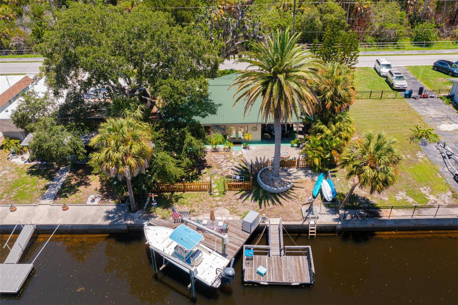 Waterfront home with Gulf access has a lift, davit, dock and floating dock for all of your water toys. This home is in like new condition with a licensed and certified remediation and remodel after Helene including a new HVAC system. This active Airbnb is fully furnished, decorated in a fun beach motif and set up for rental on a quiet road. You are located near the fun with several beaches, parks and restaurants for entertainment. This house is an opportunity to own a vacation home that supports itself as a rental or buy it and move in full time and enjoy the fun back yard with fire pit and fishing from the dock.