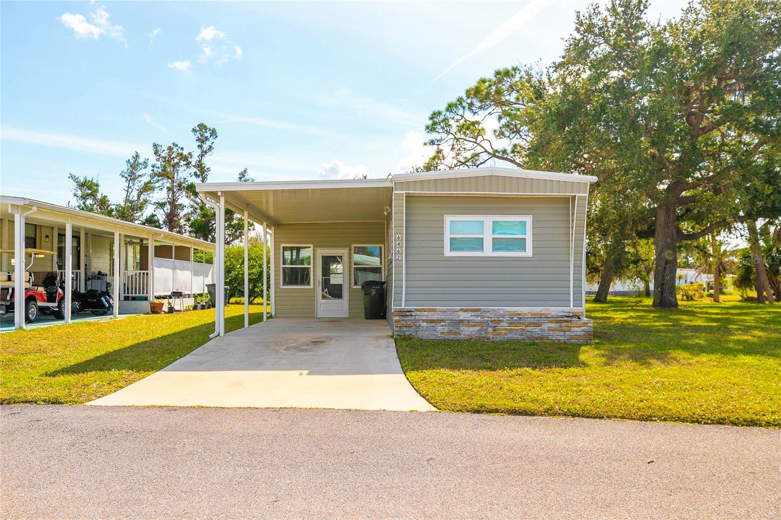This two bedroom, two bath home is situated on a quiet court in Holiday Park, make this your year-round home or your Winter getaway! In 2012 virtually everything was replaced and rebuilt the homeowners replaced all windows, installed new flooring throughout, installed a second bathroom which both baths have walk in showers, all new kitchen, with cabinets, lighting, appliances, Florida Room for entertaining, metal roof, AC, Heat Pump and siding. Truly Move In ready, Turn the key and move in !