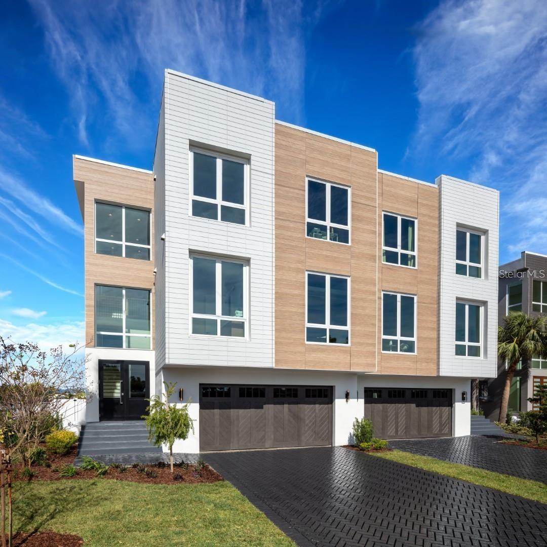 Pre-Construction. To be built. Price includes ELEVATOR and POOL/SPA. Pre-construction waterfront townhomes now selling in Treasure Island, just minutes from Madeira Beach and John's Pass. Located in the same luxury waterfront enclave featured on HGTV's Rock the Block, this limited collection of pre-construction residences offers a rare chance to own new construction in a true boater's paradise. Designed with the same architectural style and high-end features as the completed model next door, these homes are built for modern coastal living; offering the flexibility to make your own finish selections. Each home will feature solid concrete block construction, high-impact windows and flood vents, built to meet current elevation codes. Floor plans are open-concept with water views, spacious great rooms, and private outdoor areas. An oversized garage provides plenty of space for vehicles, water toys, and storage. Inspired by the completed model, kitchens are designed with premium appliance packages, quartz countertops, large center islands, custom cabinetry, and generous pantry space. The primary suites offer private balconies, walk-in closets, and spa-style bathrooms with soaking tubs, oversized showers, and designer finishes. Outdoor features may include a private heated pool and hot tub, a built-in summer kitchen, a sun shelf, and a fenced yard with a private boat slip. With direct access to the Gulf of Mexico via John's Pass, just five minutes away, these homes offer unbeatable convenience for boaters and beach lovers alike. These are pre-construction homes and are in permitting for final approval. Photos shown are from the completed model homes next door and represent similar floor plans and finishes. Buyers may have the opportunity to select certain features depending on the construction timeline. Don't miss the chance to customize your coastal retreat in one of Treasure Island's premier waterfront communities.