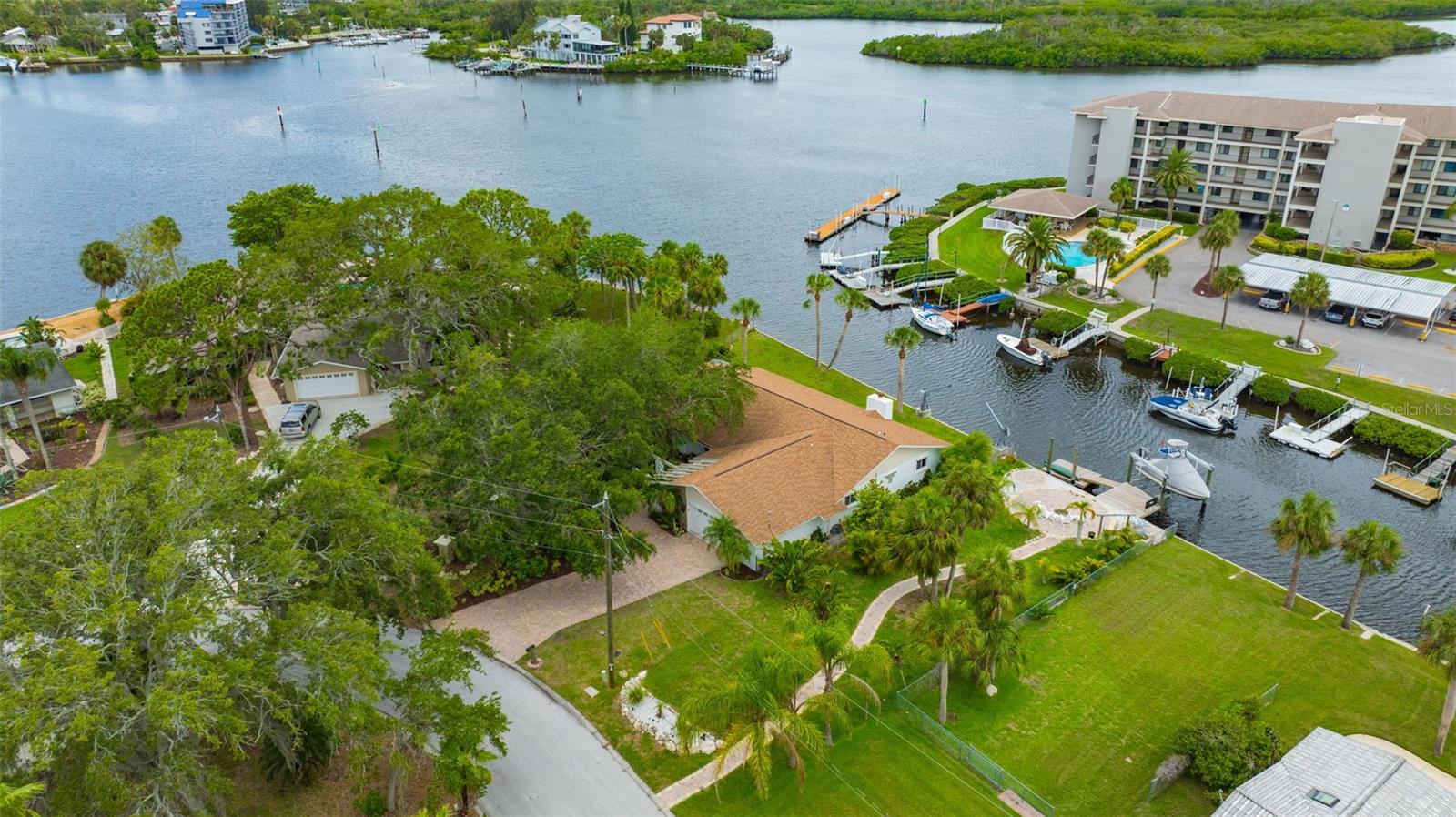 Welcome to paradise! This beautifully renovated waterfront home sits on a spacious lot with mature landscaping. Enter through the front door into the living room/dining room combo and immediately admire the views of the water. The open kitchen offers upgrades galore! Quartz countertops, wood cabinets, modern backsplash, and brand-new stainless-steel appliances. Relax in the family room next to the wood burning fireplace. The living room, dining room, family room, and all three bedrooms have been updated with modern, easy to maintain, wood look tile. The master bedroom features a walk-in closet, french doors overlooking the water, and an en suite bathroom with deep tub and separate shower and double vanity. Both bathrooms have brand new vanities with granite countertops. Step outside, the fenced in backyard is an absolute game changer! Enjoy the sunset, ocean breeze, and watch for dolphins in the screened in porch, complete with spa hookup. The backyard features 120 feet of waterfront/seawall. There are no direct next-door neighbors on either side, as there are open lots on both sides of the home. With direct access to the Gulf, this home is an ocean lover's dream. Nestled in the heart of Port Richey, you are minutes away from shopping and dining (by land and sea). The roof is five years old, and the AC unit was replaced in January 2025. This home is truly move in ready. Don't let this gem get away, schedule your showing today.