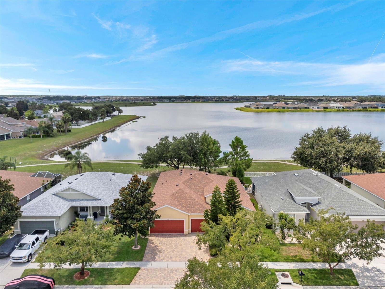 Immaculate 4-bedroom, 3-bathroom home with one of the rare direct lake views on an expansive 80+ acre lake in the sought-after Rivercrest community. Homes with this level of waterfront privacy seldom become available. Featuring a brand-new 2025 roof and freshly painted interior, this move-in ready residence offers serene lakeside living. The desirable 3-way split floorplan provides privacy and comfort for family and guests, while the open, sun-filled layout is perfect for everyday living and entertaining. Relax or entertain on the generously sized screened lanai overlooking the tranquil lake. Includes a 3-car garage and impeccably maintained interiors. Enjoy walking access to community amenities including resort-style pools, parks, playgrounds, tennis and basketball courts, and walking trails. Sessums Elementary School is a short walk away, Rodgers Middle School is about 1.5 miles, and the home is zoned for Riverview High School, known in the community for its strong academic and athletic programs. Conveniently located minutes from US Highway 301 and I-75, with St. Joseph’s Hospital South and AdventHealth Riverview each about 10–15 minutes away. Experience peaceful lakefront living with easy access to shopping, dining, and major roadways.