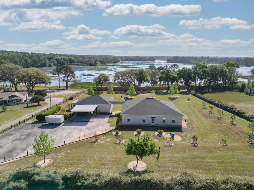 BACK ON THE MARKET! PRICED TO SELL!! Looking for that beautiful property that is close to everything but still feels like you are in the country? Then look no further! Located in Candler Estates with a Belleview address allows country living with a city address. This home sits on over two acres overlooking water views of Lake Bowers tributaries. Whether it is your morning cup of coffee or a cocktail at the end of the day, there is no better place to relax than the expansive lanai. If you are an outdoorsman or growing family you will have plenty of room to store ALL your toys in the garage with over 1200 sq. ft. of storage, attached you will find a carport to keep you dry on those rainy days. Inside the house you find a layout for family fun or a space to entertain friends, family and neighbors. With over 2500 sq ft. of living space you will find 3 bedrooms and 2 bathrooms. The game room offers a generous space for fun while it still has space for a home office. The family room right off the kitchen is spacious and has a relaxing water view. The home has too many features to list them all, you really need to schedule an appointment to see and appreciate. This property also provides a whole house generator that has four times the capacity of the current requirements. So if you have house guests that arrive in an RV, you have no problem plugging in and staying a while. This custom built home, garage, carport and generator were designed for maximum enjoyment and comfort all on 2+ acres