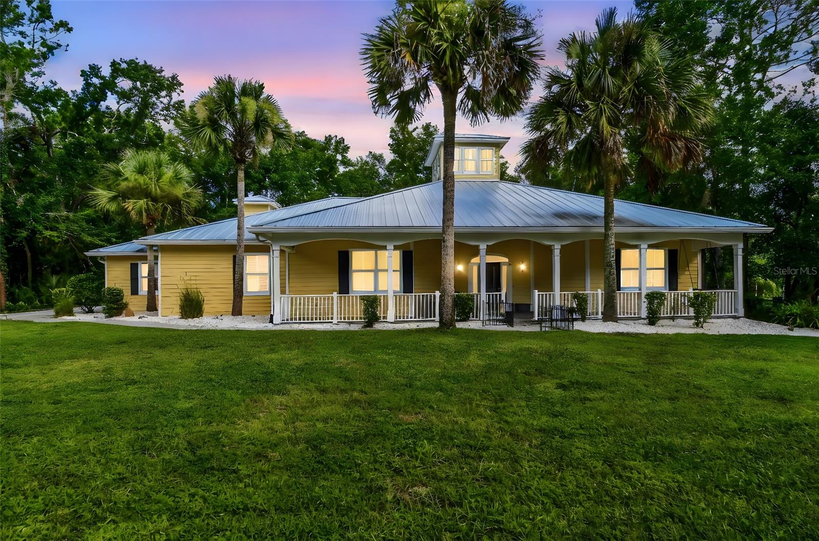 Tucked away behind a private, gated entrance and surrounded by almost 6 acres of serene land, this one-of-a-kind Key West-style retreat offers a lifestyle of peaceful seclusion with every modern upgrade already done for you. As you travel down the long drive, you'll be welcomed by your very own botanical sanctuary—think 5 acres of natural Florida beauty filled with cypress trees and wildlife, all protected conservation wetlands that will never be built on. The moment you step onto the wide paver path leading to the expansive front porch, you’ll know you’ve arrived somewhere special. Inside, elegance meets craftsmanship in a grand foyer that opens into a dramatic great room, anchored by a central whale watch tower soaring 25 feet high with twelve windows that flood the space with golden natural light. Italian travertine tile flows throughout the home, complemented by double crown molding and fine finishes at every turn. The gourmet kitchen is an entertainer’s dream, featuring 42-inch espresso wood cabinetry, a gas range with pot filler, stainless steel apron sink, granite countertops, a new refrigerator (2023), and double convection wall ovens—all designed to inspire your inner chef. This spacious layout includes four bedrooms and three full bathrooms, each with direct access to a walk-in shower and walk-in closet—ideal for multi-generational living or guest privacy. The fourth bedroom easily transforms into a home office or creative studio. The oversized primary suite is a true sanctuary, offering private access to the patio and hot tub. The ensuite bathroom is spa-worthy, complete with dual vanities, a large jetted soaking tub, a separate toilet room, and a massive walk-in closet. Step through the wall of sliding glass doors and into your own tropical escape: a 23,000-gallon resurfaced pool (2024), paver deck, and built-in stainless steel BBQ station, perfect for hosting. Adjacent sits a 36-jet hot tub with views of your private preserve—pure tranquility. The home also boasts a brand-new metal roof (2024), a new six-zone sprinkler system (2024), a fully fenced yard ideal for pets, and sits over 50 feet above sea level. Don’t forget a large two-car garage, dedicated RV/trailer parking pad, and a separate shed for landscaping tools and mower storage. Plus, with no HOA or deed restrictions, your lifestyle is yours to design. You’ll feel a million miles from it all, yet still close to modern conveniences. Ideally situated near I-75, this location offers effortless commuting to Tampa and beyond. Spend your weekends exploring the Tampa Premium Outlets or Shops at Wiregrass, just a short drive away. Golf enthusiasts will love the easy access to nearby courses, while a wide variety of shopping, dining, and entertainment options ensure there’s always something to enjoy close to home. Homes like this don’t come around often, schedule your private tour today and discover the magic of true Florida living.