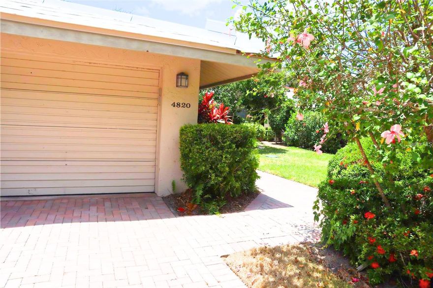 Welcome to one of The Landings' best-kept secrets. Tucked inside the intimate Carriage House community, this 2-bedroom, 2-bath residence delivers the feel of a single-family home wrapped in the ease of maintenance-free living ? and it's move-in ready.  Inside, tile flooring flows throughout, anchoring a bright, open layout that feels larger than its footprint suggests. The updated kitchen impresses with a modern aesthetic, solid surface counters, and finishes that feel fresh and intentional, not dated. Both bathrooms have been thoughtfully remodeled, featuring solid surface counters and elegant tile enclosures. A wood-burning fireplace adds warmth and character, making this home as livable as it is lovely.  Your private one-car garage sits just beyond a charming paver driveway shared with only one neighbor.  This quiet, neighborly setup that feels nothing like a typical condo. Step outside and enjoy two generous lanais plus a courtyard patio designed for the kind of everyday outdoor living that makes Sarasota so irresistible.  Peace of mind comes standard: a brand-new 2026 roof means this home is as solid as it is stylish. Offered unfurnished and ready for immediate occupancy.
Residents of Carriage House II enjoy access to a beautiful pool and clubhouse, all set amid lush, manicured grounds surrounding a tranquil lake with fountains, turtles, and ducks. Membership to The Landings Racquet Club is available but not included or required ? a wonderful option for those who want the full lifestyle package. The Landings' coveted location west of the Trail puts everything within easy reach.