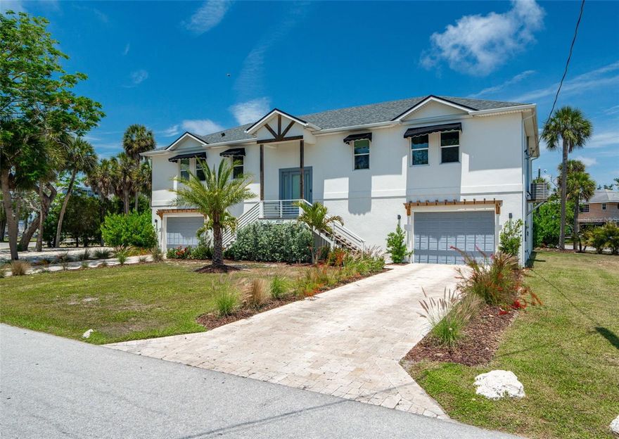 2020 Elevated custom block home delivers the Gulf Coast lifestyle.  No deed restrictions, no pet restrictions, no lease restrictions, no HOA, No CDD.  Constructed with block on both levels, hurricane-impact windows and doors, spray foam insulation, and living areas positioned 17 feet above sea level, this storm-conscious home offers genuine peace of mind — the living spaces have never flooded.
Positioned on an oversized corner lot minutes from the Cotee River and Gulf access, this is a true Gulf Coast lifestyle property built for boating, entertaining, and year-round Florida living. American Marina sits directly across the street — boat slips, dry storage, boat and jet ski rentals, and immediate water access. Waterfront dining by boat, downtown New Port Richey, Sims Park, multiple boat ramps, and golf cart-friendly entertainment are all close by.
Inside, soaring ceilings and an open-concept split floor plan create a bright, spacious coastal contemporary feel. Quartz countertops, upgraded finishes, French doors, water views, and Gulf breezes carry throughout. The owner's suite features a soaking tub and spa-style walk-in shower system. Oversized secondary bedrooms — including a second primary suite — offer ideal flexibility for guests or multigenerational living. A dedicated laundry room with built-in storage completes the interior.
What sets this property apart is the 2,000+ sq ft five-car garage and flex space. Oversized bays, tandem parking, an iron security entry door, luxury vinyl flooring, and generous storage elevate this far beyond a traditional garage. A dedicated built-in content studio is already in place — ideal for creators, entrepreneurs, or private office use. Car collectors, boaters, RV owners, remote professionals, and hobbyists alike will find room to thrive.
Outdoor living was designed for entertaining and relaxation: a screened upper deck with retractable awnings, custom privacy landscaping, and an 18×9 Michael Phelps swim spa perfect for fitness and resort-style living year-round.
The details that matter: boat parking on-site, golf cart friendly, no HOA, no CDD, no restrictive deed limitations. The oversized lot accommodates RVs up to 45 feet with full sewer hookup and 50-amp service already installed. Seller will consider Bitcoin. Adjacent lots available — rare compound potential for multigenerational living, guest homes, or a private Gulf Coast retreat.
Keywords: High and dry, VA, FHA, cash, conventional, elevated construction, flood-conscious construction, energy-efficient home, smart thermostat, screened balcony, screened lanai, outdoor kitchen potential, coastal retreat, Florida retreat, second home, seasonal residence, snowbird, water access, Gulf Coast retreat, private oasis, custom coastal retreat, executive home, estate-sized lot, corner lot, oversized driveway, storage for boats and toys, hurricane-resistant, recreational lifestyle, luxury flex space, home-based business setup, creator-friendly workspace, fitness retreat, spa-inspired primary bath, designer finishes, custom-built luxury, Florida relocation, move-up buyer, retirement lifestyle, marina lifestyle, cross breezes, turnkey coastal living, RV, boat, toys, no CDD, workshop, toy garage, storm-ready, resilient home, luxury coastal property, custom estate, private retreat, entertainer's dream, tropical landscaping, palm trees, near Gulf beaches, luxury outdoor living, storage compound, digital entrepreneur, salt-life lifestyle.