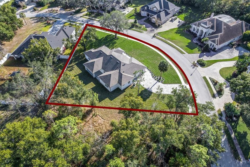 One or more photo(s) has been virtually staged. Brand new, spacious, and impeccably designed—this contemporary 4-bedroom, 3-bath custom home is tucked away on a quiet cul-de-sac in a gated enclave on the highly sought-after north side of Silver Lake, with NO HOA restrictions. Why wait months to build when you can move right in and enjoy nearly 3,000 sq. ft. of thoughtfully designed living space on over half an acre, surrounded by other beautiful custom homes? From the moment you enter, the grand foyer sets the tone with soaring ceilings, tray details, and an open, light-filled layout. The living room, dining area, and gourmet kitchen flow seamlessly together, creating the perfect space for both everyday living and entertaining. High-end wood-look tile runs throughout the home, complemented by tall doors and ceilings that enhance the modern, upscale feel. The chef’s kitchen is a showstopper, featuring premium quartz countertops (carried through all bathrooms), soft-close cabinetry, a range top with vented hood, double ovens, and abundant workspace—ideal for hosting and culinary enthusiasts alike. Just off the main living area, the oversized covered back porch overlooks a massive backyard that is partially fenced and ready for a pool, playground, or outdoor oasis.  The split-bedroom floor plan offers exceptional privacy and flexibility. The expansive primary suite features a spa-like bath with double vanities, a walk-in shower, soaking tub, and a massive walk-in closet with custom built-ins and organizers. A secondary bedroom includes its own private en-suite bath—perfect for in-laws or guests. The two additional bedrooms are oversized by today’s standards, each with a walk-in closet, and are separated by a third full bath with double vanities and a tub/shower.  Additional highlights include a well-appointed laundry room with a convenient dog-washing station, a long pavered driveway ideal for multiple vehicles when entertaining, and a peaceful setting that still offers quick access to shopping, dining, hospitals, and everyday conveniences.  This is a rare opportunity to own a truly turnkey, high-end home in one of Leesburg’s most desirable areas—without HOA limitations. If you’re looking for the premier place to plant your roots, look no further. Schedule your private showing today before this exceptional home is gone. *Aerial photo property lines are approximate and to be verified by buyer.