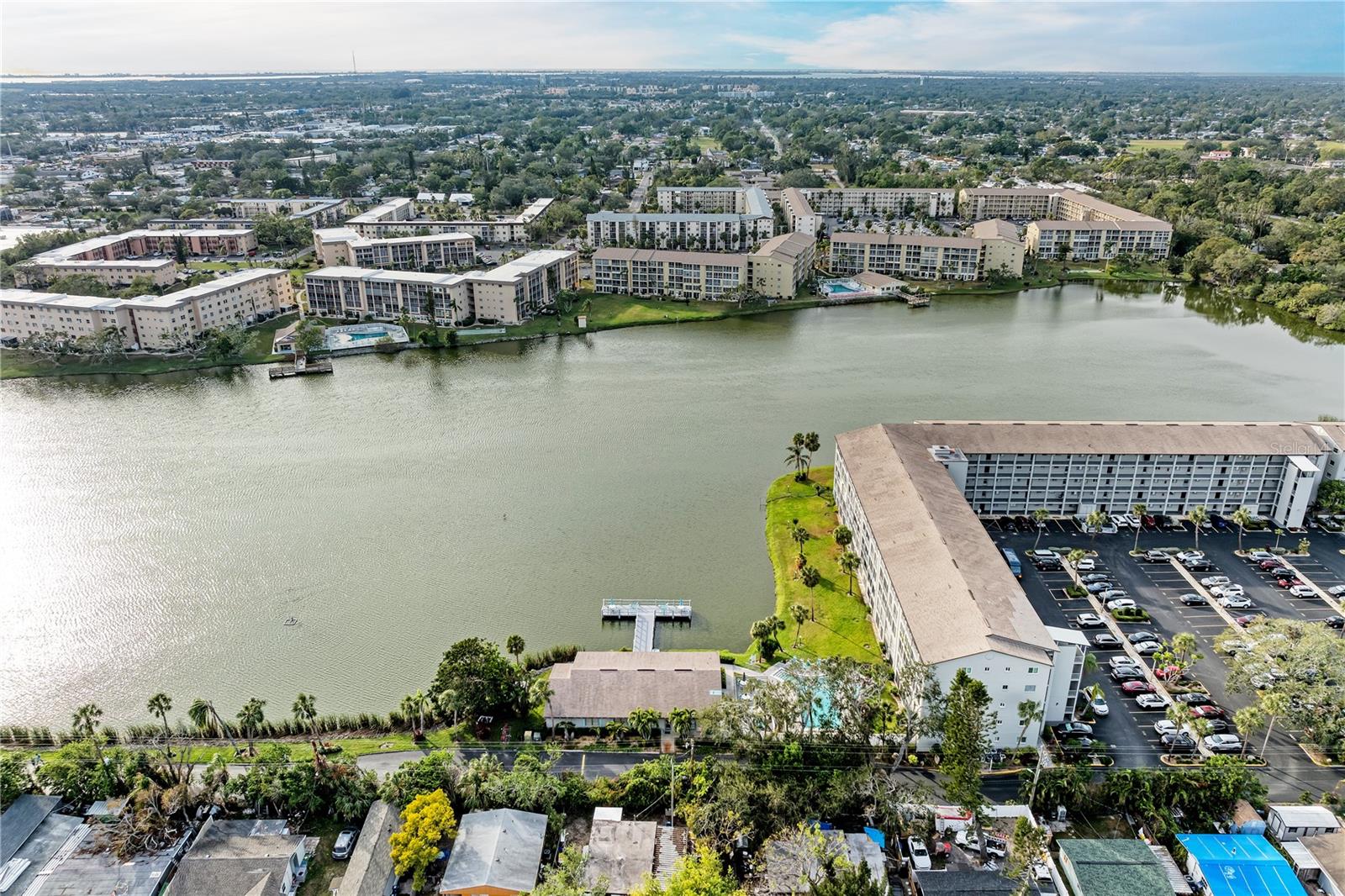 BEAUTIFUL WATER VIEWS! 4TH FLOOR UNIT! FULLY FURNISHED! LOWER HOA FEES IN THIS BUILDING! Welcome to Bayshore On The Lake, a well established 55+ community just a few miles from our renowned Gulf beaches. One of the best buildings in this community... well managed and well located. This spacious, bright, and open condo offers 2 bedrooms and 2 bathrooms with the option to include the furniture for a seamless move-in process. Gently used for only a couple of months each year, this unit is primed and ready for a new owner and has not been used as a rental by the current owner. Separate yourself from the rest with an unbeatable lake view, perfect for morning coffee or evening cocktails. The rear screened porch is large and spans the width of the unit. Also just steps away from the community pool and clubhouse for added convenience. the low hoa fees even come w/ cable and internet included! Local dining, shops, and destinations are just a stones throw away. Surrounded by everything but still feels as if you're a world away. Perfect unit for a variety of lifestyles... full-time, part-time, or future investment. Elevator access in the building makes reaching your new 4th floor unit a breeze. Come see this premium unit and find out why this community is highly desired. Schedule your showing today!