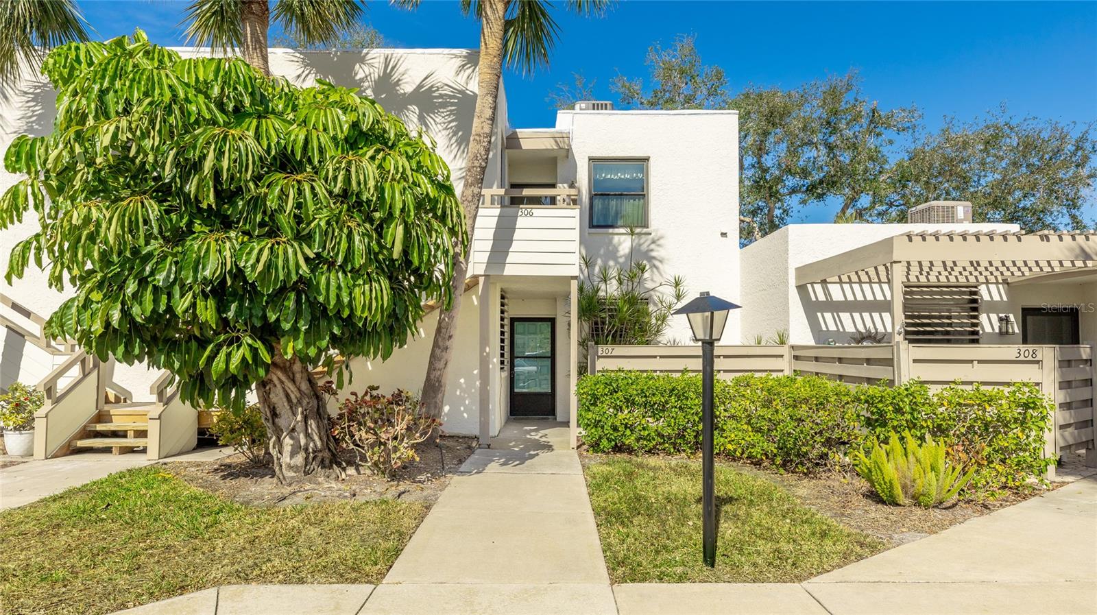 Nestled within the lush, Audubon-certified bird sanctuary of Wildewood Springs, this beautifully updated 2-bedroom, 2-bathroom residence offers a rare blend of tranquility and convenience. Wake up to the soothing sounds of nature and enjoy breathtaking sunsets over the lake from your private lanai. Inside, this unit boasts tasteful updates, blending modern comforts with a relaxed coastal feel. The open concept living space is bathed in natural light, while the kitchen and bathrooms have been thoughtfully refreshed to enhance both style and function. Step outside and immerse yourself in the enchanting surroundings, where Ospreys, Eagles, Herons, and Egrets grace the skies, and Otters, Turtles, and Ducks call the lake home. Whether you're an avid birdwatcher or simply appreciate the beauty of nature, this preserve-like setting is a true retreat. In addition to its serene atmosphere, this home is ideally located just minutes from pristine Gulf beaches, vibrant shopping, and fine dining. For golf enthusiasts, a city golf course is just five minutes away, offering the perfect opportunity to practice your swing. Family members of IMG Academy students will appreciate the proximity to the renowned sports campus. Plus, convenience is at your doorstep with three major grocery stores nearby, ensuring effortless access to everyday essentials. Residents also enjoy access to a tennis and pickleball court, as well as two community pools. Furniture available for purchase.