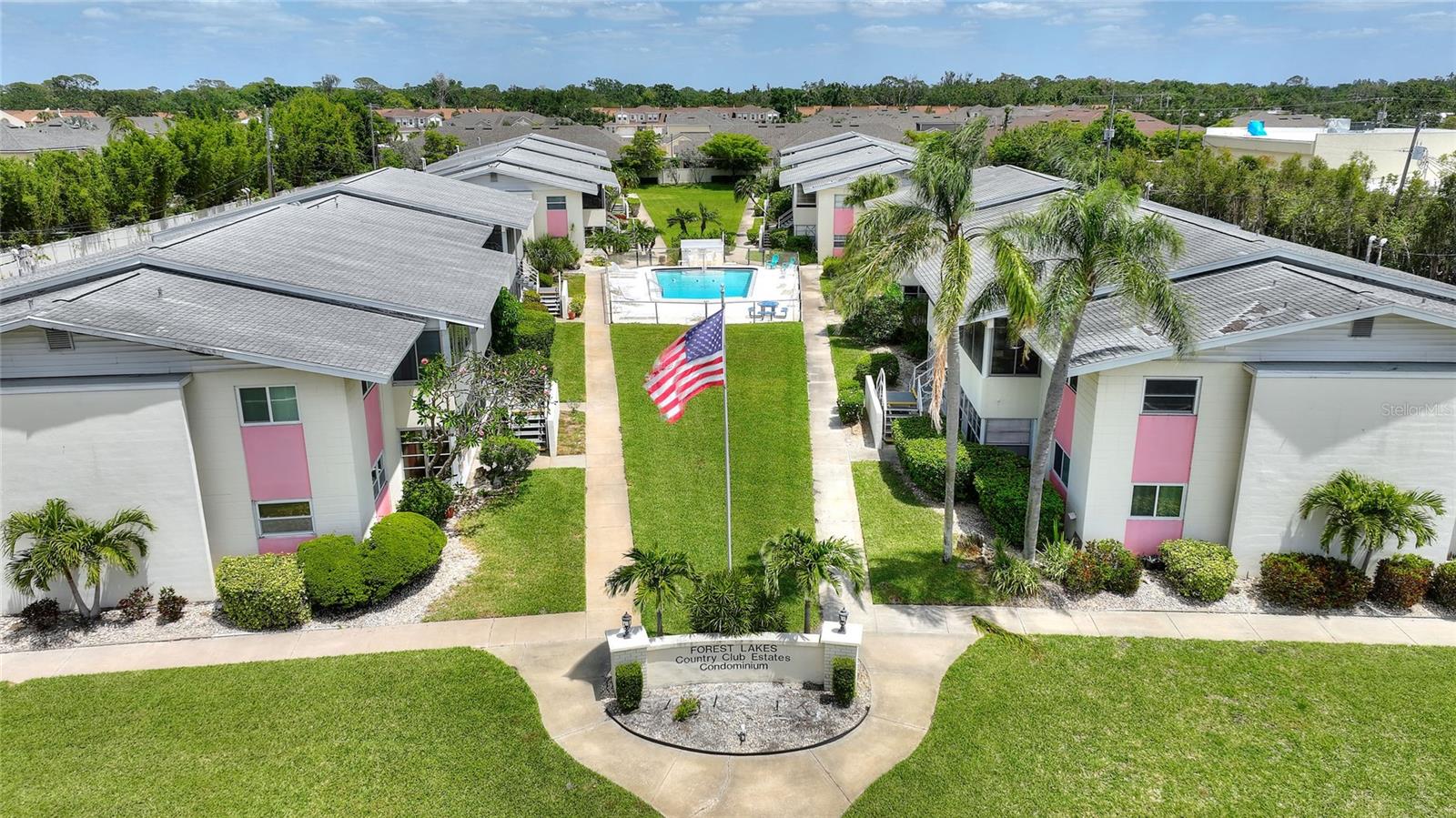 Welcome to Forest Lakes Country Club Estates! This beautifully updated first-floor condo offers 2 spacious bedrooms, 2 bathrooms, and 2 covered parking spaces—perfectly blending comfort and convenience. Step inside to a bright, open-concept layout featuring a formal dining area and a generous family room that flows seamlessly into a large kitchen with new appliances, ample counter space, and its own eat-in area. You'll love the bonus of the screened-in porch—ideal as an additional living area, home office, or simply a peaceful spot to enjoy your morning coffee while overlooking the serene, manicured grounds. The primary suite is a relaxing retreat with its own private en suite, while the second bedroom and bath offer plenty of room for guests or family. The home features fresh paint and stylish modern finishes throughout. Just steps from the community pool and located near vibrant dining, shopping, and only minutes from Siesta Key and Lido Key beaches—with the Legacy Trail nearby—this is Sarasota living at its best!