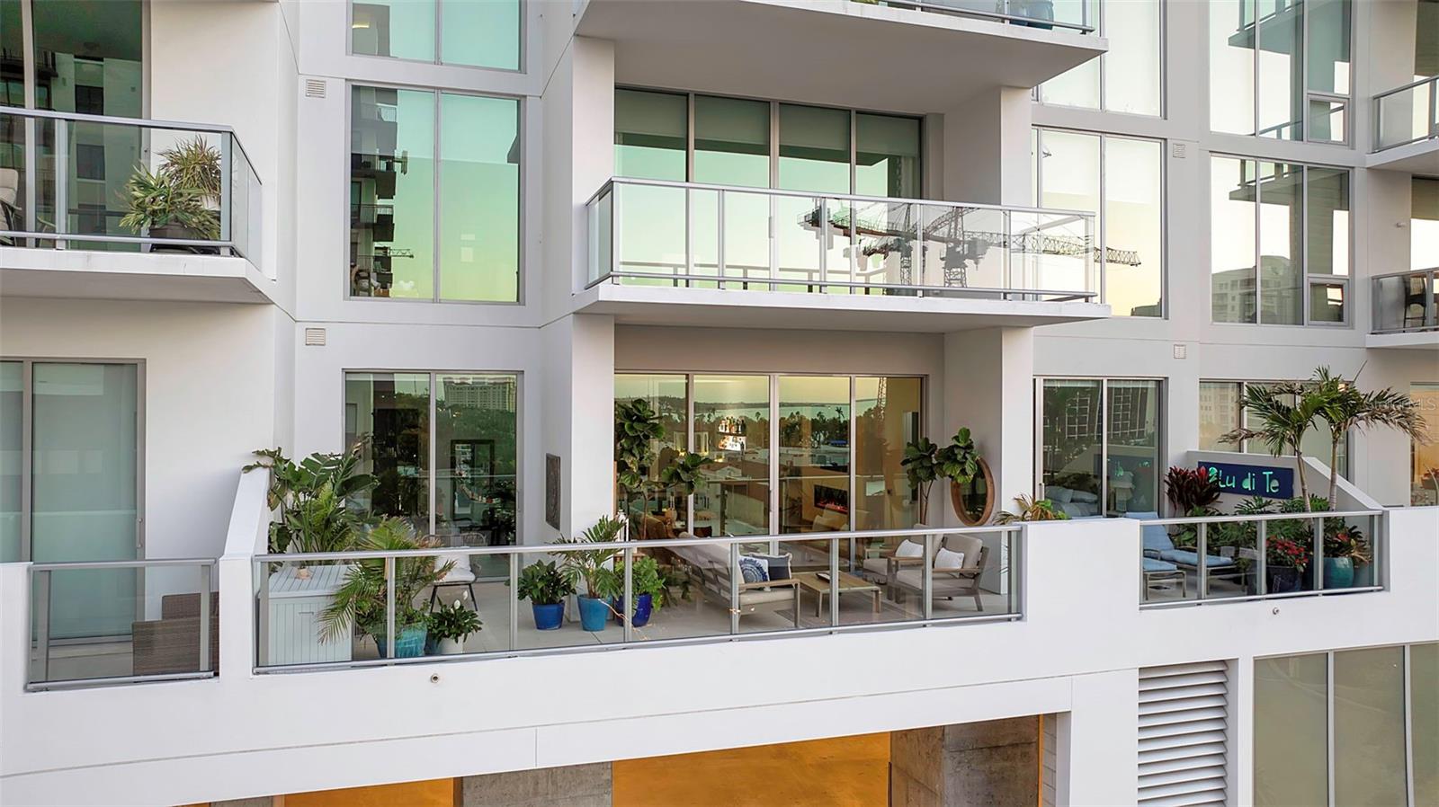 Welcome to the pinnacle of downtown Sarasota living at 301 Quay Commons #503 in the prestigious BAYSO condominium.
This professionally designed residence showcases the vibrant urban lifestyle through floor-to-ceiling windows, soaring 12-foot ceilings, and premium finishes throughout. The chef's kitchen is a culinary masterpiece featuring JennAir appliances, European Italkraft cabinetry with soft-close functionality, convenient pull-out drawers, and luminous quartz countertops. Ample storage space throughout ensures a clutter-free lifestyle, while the open floor plan flows seamlessly to a massive outdoor terrace with glass balcony railings ( 550 Square Feet!) perfect for enjoying the spectacular cityscape and downtown views.
Perfectly positioned within BAYSO, this residence offers direct same-level access to the resort-style pool, splash lounge, and dog park—making luxury amenities effortlessly accessible. Two assigned parking spaces near the elevator provide convenient arrivals and departures. The first-floor amenity collection delivers comprehensive luxury with its stunning pool and spa deck, state-of-the-art fitness center, co-working space, resident club room, and more. With 24/7 security and dedicated staff, BAYSO offers the ultimate lock-and-leave lifestyle for those with dynamic lives.
Located in the vibrant Quay Sarasota, this residence places you at the epicenter of downtown culture and convenience. Step outside to dine at Ocean Prime, stroll to Whole Foods, explore world-class galleries and theaters, or enjoy morning walks along the waterfront at The Bay Park—all without ever needing your car. The pristine beaches of Siesta Key and Lido Key await just minutes away, completing this extraordinary city lifestyle that represents true luxury living in Sarasota's most sought-after community.