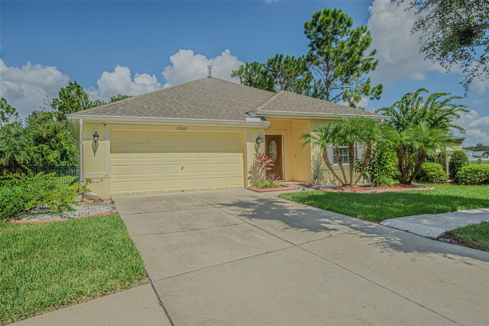 Welcome to this beautifully maintained 4-bedroom, 3-bath, 2-car garage, single-story home on a spacious corner conservation lot in the sought-after guard-gated community of Live Oak Preserve. Ideally located just across from Wharton High School, this home offers easy access to top-rated schools and a host of resort-style amenities, including a clubhouse, a large resort pool with a splash area for kids, lap pool, hot tub, fitness center, tennis courts, and multiple recreational spaces.
This move-in ready home has been thoughtfully updated inside and out. Recent improvements include Sherwin-Williams professional hand-painted interior and exterior (primed and painted), a Culligan whole-home water treatment system, new metal fencing along the side and backyard (with garden space), and a huge 25' x 15' screened-in patio with privacy shades. Additional upgrades include a new microwave, washer and dryer, new filter gutters around the entire home, and solar-tinted double-pane windows and doors, providing energy efficiency and a quiet interior.
The open-concept layout features a spacious living and dining area, an updated kitchen with granite countertops, stainless steel appliances, double sinks, and a breakfast bar overlooking the oversized 25' x 16' family room that flows seamlessly into the screened patio with serene conservation views.
The primary suite is generously sized and includes two walk-in closets, a garden tub, a walk-in shower, and dual vanities. The smart split-bedroom design offers flexibility for multi-generational living or a private in-law suite.
Major systems are in great shape with a newer roof and AC system (both installed in 2022).
Perfectly located near I-275, Tampa International Airport, Wiregrass Mall, Tampa Premium Outlets, golf courses, restaurants, healthcare, and more — this home truly combines comfort, convenience, and community living.