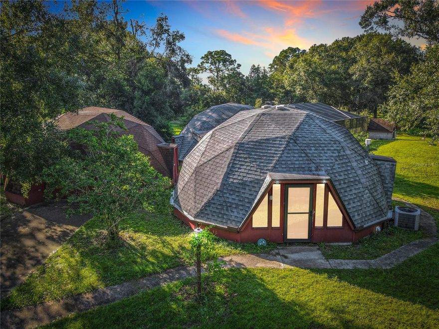 Check out this forward-thinking home that defies the traditional box, where every angle is intentional in this amazing new property hitting the market today!

Welcome to a one-of-a-kind dome-style residence that blends architectural innovation with everyday comfort. This striking three-bedroom, two-bath dome home is not only visually captivating, but also designed for functionality and efficiency. Even the detached dome garage mirrors the architectural theme, creating a truly cohesive and rare property.

Step inside to discover a floor plan that separates living spaces from the bedrooms, offering both privacy and flow. The kitchen boasts stainless steel appliances, a large walk-in pantry, and modern conveniences including two AC units, two water heaters, and a water softener system.

Set on 2.93 acres, the property offers endless possibilities. Entertain under the spacious lanai, lounge by the pool, or enjoy the charming chicken coop out back. With room to build an additional home or add a tiny home, this property’s potential expands as far as your imagination.  Garage is wired with 200 so appliances can be added if a client wants to convert the garage to a livable space 

What truly sets this home apart is the versatility of the dome design. Beyond a private residence, it presents an incredible opportunity as a VRBO or Airbnb investment, or even as a boutique wedding and event venue. The unique structure is a natural conversation starter—guests will remember it long after their stay.

If you’ve been waiting for a property that’s unlike anything else in Florida—architecturally bold, highly functional, and full of investment potential—this dome home is it.