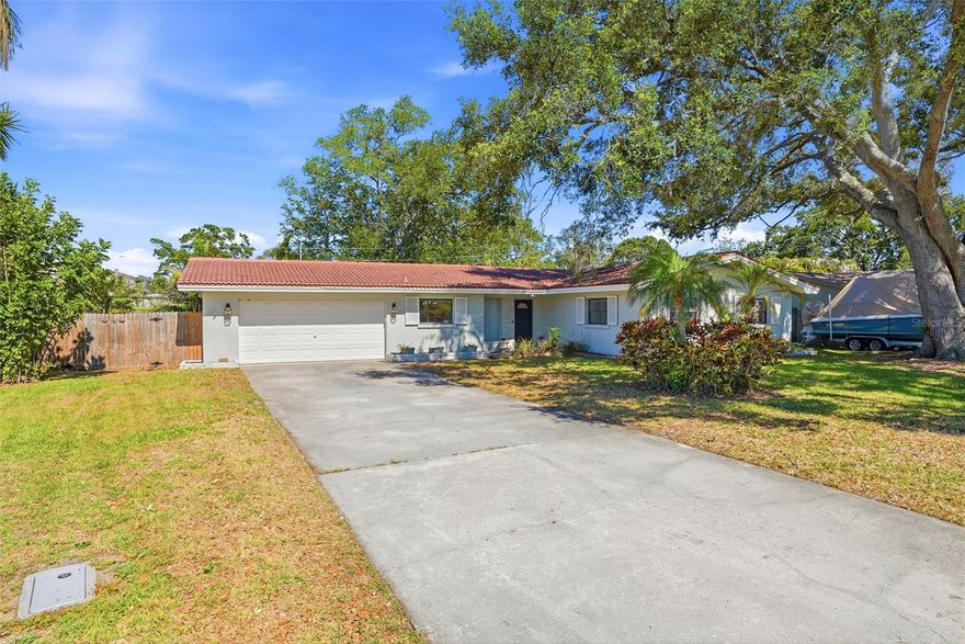 Move-in ready 3BR/2BA ranch, 5-min walk to coveted Plumb Elementary -- no HOA, no CDD, Flood Zone X. This 1,830 sq ft Douglas Manor Park home shows beautifully: renovated kitchen with quartz counters, a large center island, stainless appliances, and abundant cabinet storage; porcelain tile baths with a dual vanity in the guest bath; brand-new luxury vinyl plank flooring in all three bedrooms; and a wood-burning fireplace with porcelain marble surround in the open living area. Bright, entertaining-friendly layout opens to a private screened porch and a big fenced yard -- room for a firepit or future pool. Block/stucco construction, tile roof, 2-car attached garage (20x22). Flood Zone X = lower insurance and no mandatory evacuation. 0.21-acre lot on quiet Viewtop Drive -- central Pinellas, quick access to US-19, the beaches, and downtown.