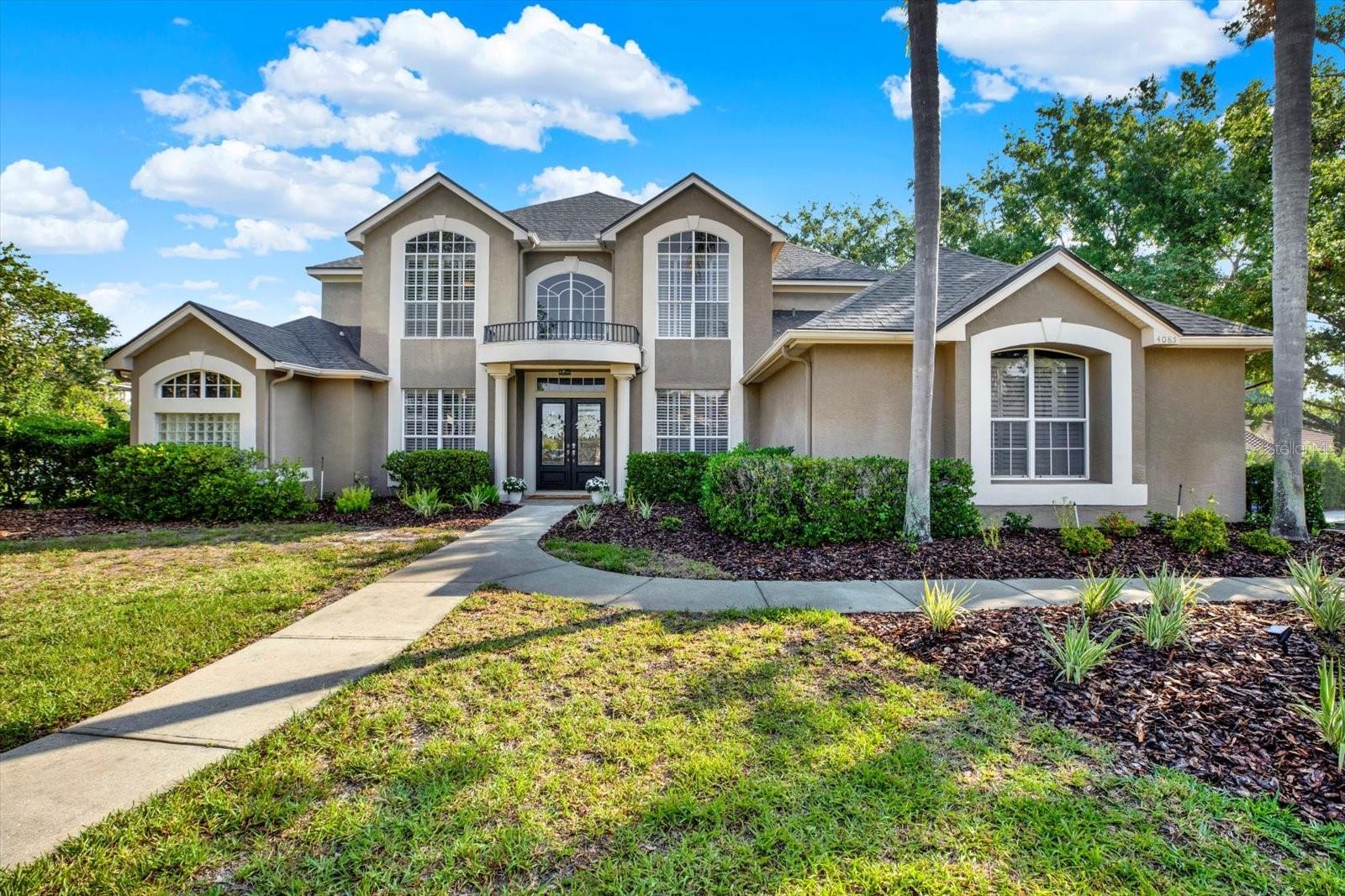 Welcome to this exceptional executive home featuring 4,450 sq ft -Primary Suite on first level- with 5 bedrooms 4 1/2 baths and a dedicated office space. This luxury home is located in the sought after gated community of Presidents Landing in the highly desirable Lansbrook subdivision.
Set on a generous corner lot, this residence includes a three-car garage equipped with built-in overhead storage. As you enter through the custom double doors, you are welcomed into a grand foyer that opens to a 2 story formal living room, complete with a cozy fireplace and 2 sets of double doors leading to the stunning views of the custom pool and lanai. A formal dining area fit with plantation shutters and tons of natural light add to the elegance of this home.
The first level is designed for convenience, housing a private office and the expansive primary suite and a pool bath. The luxurious primary suite features double doors leading to the pool area, two generous walk-in closets, and a spacious ensuite complete with dual sinks, a large walk-in shower, a private water closet, and a jetted tub. On either side of the home, 2 sets of stairs conveniently lead to the upper level, which features 4 additional bedrooms and 2 full bathrooms, including an oversized 4th bedroom that can easily be transformed into a spacious bonus/game/movie room.
The open-concept kitchen is a chef's dream, featuring granite countertops, wood cabinetry, stainless steel appliances including double ovens, a wine cooler and a brand new refrigerator. Plenty of space to entertain with abundant counter space and bar seating. The kitchen seamlessly connects to the family room and breakfast nook, with a half bath nearby for guest convenience.
Highlights of this home include soaring ceilings, plantation shutters, tall doors, wood plank porcelain tile flooring, water softner, laundry room, extra storage space under both stairwells, a newer roof (2022) and a new pool pump with wifi controllability.
The entire first level wraps around a beautifully designed lanai showcasing a lagoon-style pool and spa, perfect for entertaining. The expansive screened lanai features beautiful wood plank ceilings and includes a custom wet bar and an additional seating area. The fenced backyard offers two paved decks ideal for outdoor activities, sunbathing, gatherings, and grilling. No flood or wind damage from past hurricanes.
Not only is Lansbrook a Golf Cart Community with Top Rated Schools, President’s Landing features an exclusive residents-only boat launch and day docks for easy access to Lake Tarpon. Additionally, Lansbrook’s Lakefront Park offers day docks, a boat launch, a playground, and scenic walking trails. The Commons provides a variety of recreational options, including pickleball, basketball, volleyball, soccer, and a playground for family fun. Enjoy the nearby Pinellas Trail which extends to 255 acre John Chestnut Park and the nearby YMCA.
The Lansbrook community not only boasts a wealth of amenities but is also centrally located to access the surrounding cities of the Greater Tampa Bay Area and the Tampa International Airport. Residents can take advantage of the beaches along the coastline and stunning award-winning Caledesi and Honeymoon Island only 13 miles away. Experience all that Tampa Bay has to offer including sporting and entertainment events, theme parks, the Florida Aquarium and a host of dining and shopping options, making this the ideal place to call home!