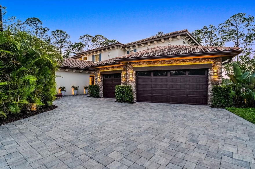 Welcome to 10122 Royal Island Ct, the only two-story Custom-Built Lakefront home in the desirable Royal Cypress Reserve guard-gated community, featuring an exceptional Lakefront setting that embraces nature with No Neighbors to be seen from your private paradise! This is NOT another Toll Brothers model home, rather it’s a resort-style, modern property with an Open Floor Plan featuring 5000 sq ft, including five ensuite bedrooms, a total of 5 full bathrooms, 2 powder rooms, a fabulous separate entertainment area, relaxing swimming pool and spa, and so much more. This Lakefront Masterpiece, built in 2022, includes the ultimate Dock with a 24ft covered Boat Lift and a Double Jet Skit covered lift built with a Tile Roof and all composite decking for years of easy maintenance. Whether you prefer quiet reading by the pool and spa or watching Disney fireworks at night from your custom Dock, this residence is impeccably maintained and has everything to offer. The entrance welcomes you with a serene water fountain leading to the 6ft x 8ft Pivot Glass Front Door that opens to the Foyer, making a unique, truly high-end experience. Enter the open floor plan of the Kitchen – Dining - Grand Room with soaring coffered ceilings and wood inlays. The gas and wood-burning Fireplace is a focal point of the Grand Room as you relax with 12 windows and 9-foot Sliders saturating the room with inviting natural light. The heart of this home is the truly gourmet kitchen with high-end finishes, featuring top-of-the-line stainless steel appliances, a Dual Fuel 48’’ Monogram double oven range, custom dual tone cabinetry, quartz countertops, a 48’’ Stainless Refrigerator, a built-in Miele Coffee Maker, a Wine Fridge, and more. The primary bedroom suite on the first floor boasts unparalleled lake and pool views, a luxurious en-suite bathroom with dual vanities, a walk-in shower with custom Steam controls, a separate soaking Tub, and custom blinds, including two walk-in closets with organizer shelving. The Office on the first level facilitates all your at-home working needs. Creative Laundry room with separate 2nd Refrigerator and Custom Cabinetry is like another Kitchen in quality and design. Two additional bedrooms on the first floor and Two more bedrooms on the second floor, including a second Primary Suite upstairs with Double vanities, Dual Closets, and inviting lake views. The upstairs entertaining area has amazing views from the numerous windows. It features state-of-the-art electronics, including a 165’’ Laser Projection TV System, surround Sound, and Dual Subwoofers to make that movie experience come to life. The custom-built bar makes this entertainment area fun for family and friends to relax. Watch fireworks or enjoy the Lakefront from the 2nd story on the quiet covered Lanai / Porch. The saltwater system Pool and Spa is warm and inviting with its dark interior finish and elevated Spa, as it overlooks the large covered Lanai with a built-in summer kitchen with separate Grill, Refrigerator, entertainment sink, and ample Bar seating. Situated adjacent to Disney property, in the esteemed community of Royal Cypress Preserve, residents have access to a wealth of amenities, including a zero-entry pool, clubhouse with catering kitchen, fitness center, dog park, and playground. Located near world-class dining, shopping, local theme parks, unlimited entertainment options, and top-rated schools. Don't let this showcase home pass, call today for a showing!